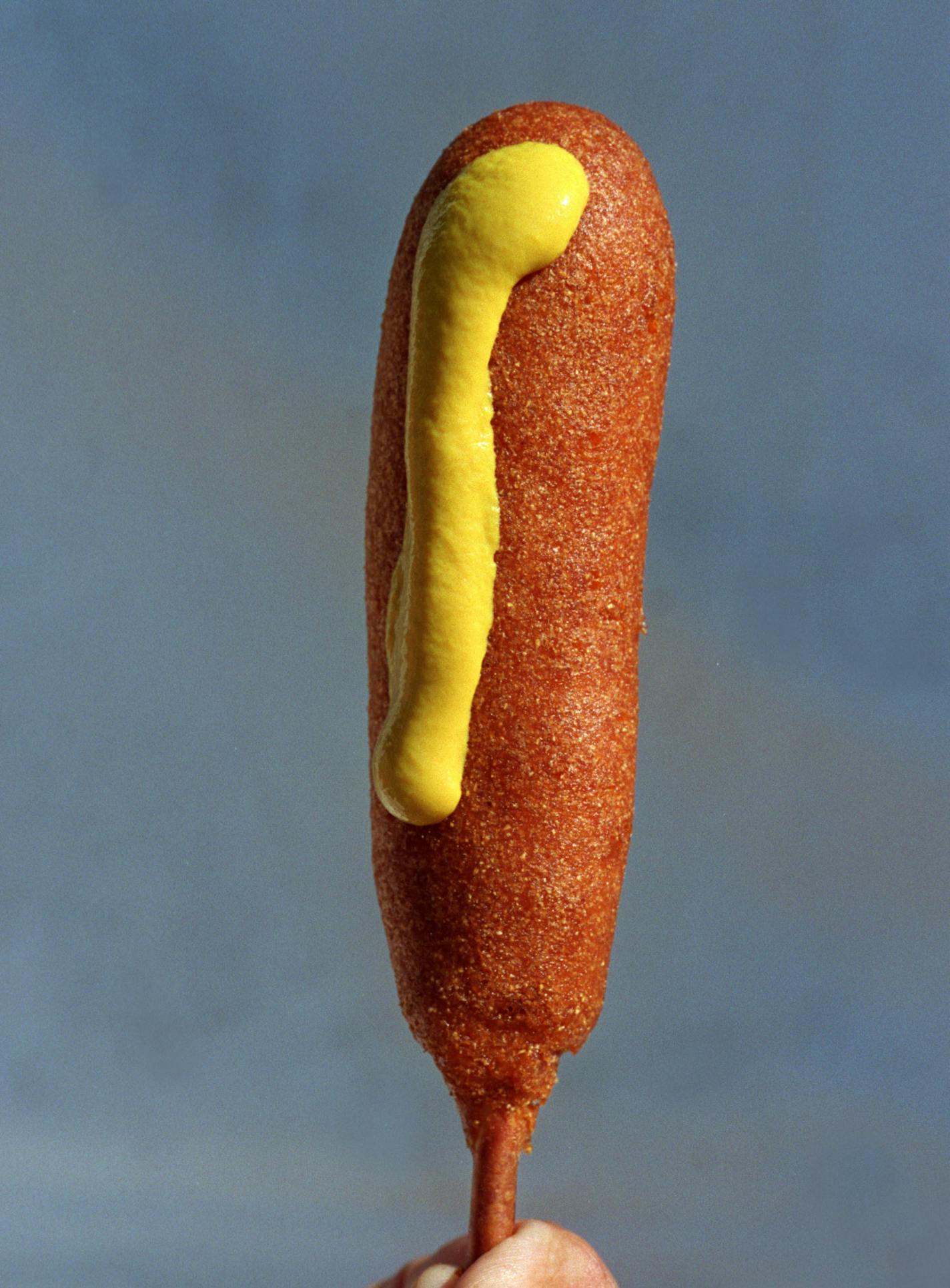 GENERAL INFORMATION: Food on a stick at the Minnesota State Fair.
IN THIS PHOTO: Falcon Heights, Mn.,--Sat. Sept. 4, 1999--A Corn Dog (with mustard) sold for $2.00 last year at the Minnesota State Fair.