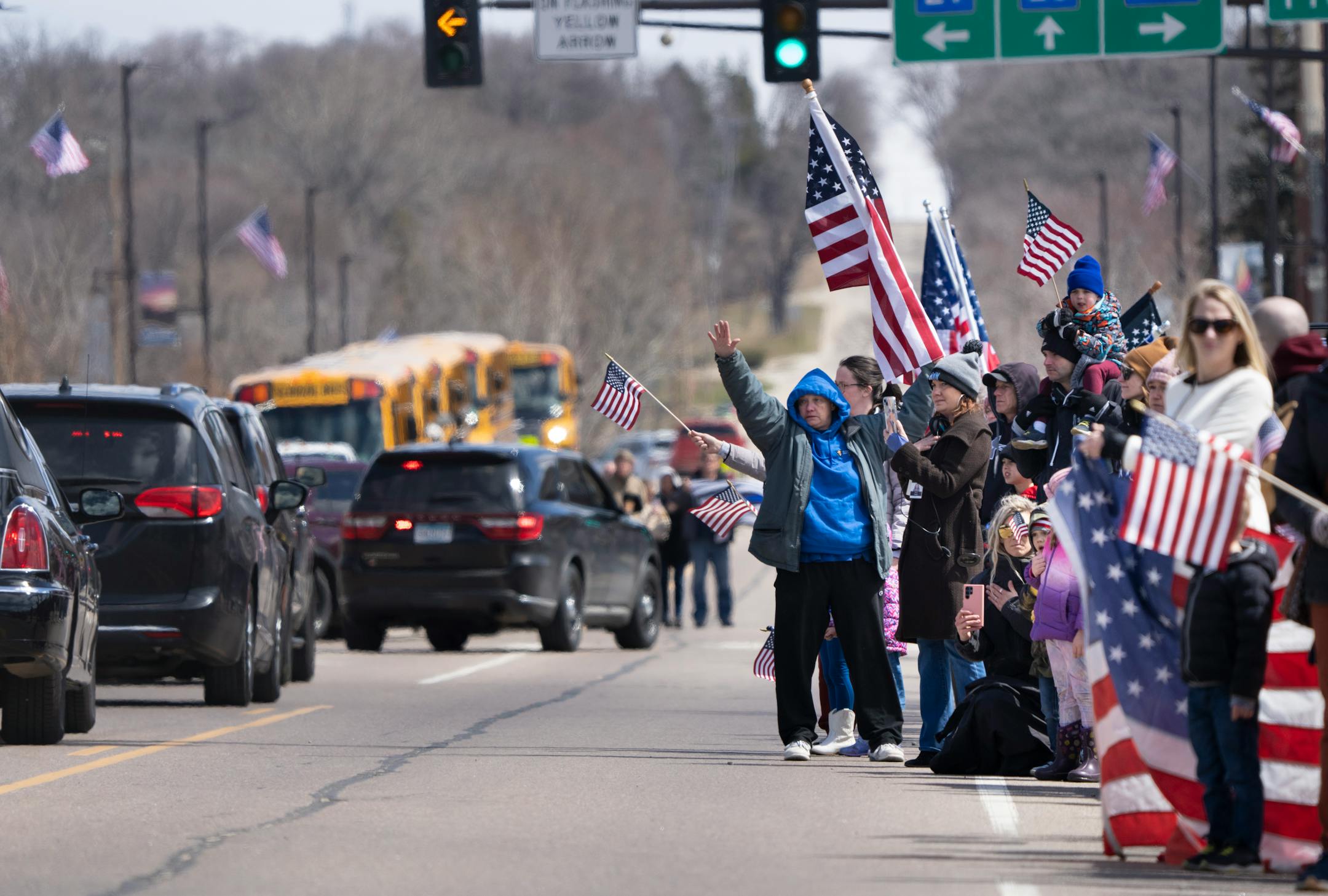 People line the streets of downtown Glenwood signaling support for the funeral procession after the visitation and funeral of Pope County deputy Josh Owen.