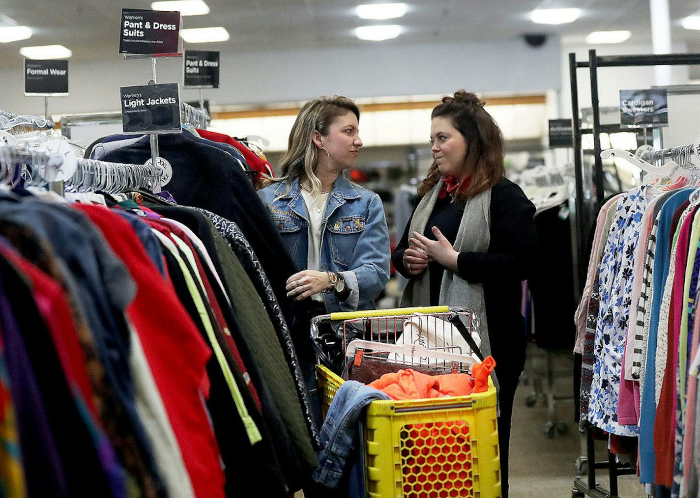 Dana Logan, left, and Mady Lipkin, seen commenting on a women's jacket with there facial expressions, are the thrifting team behind Kollektiv Mpls, and were shopping at Unique Thrift store Wednesday, March 27, 2019, in New Hope, MN. The women look for, among other things, vintage items with classic brands as well as brands with tags saying there were made here in the US.] DAVID JOLES •david.joles@startribune.com Secrets of the super thrifters! With bounty from de-cluttering Marie Kondo-inspired