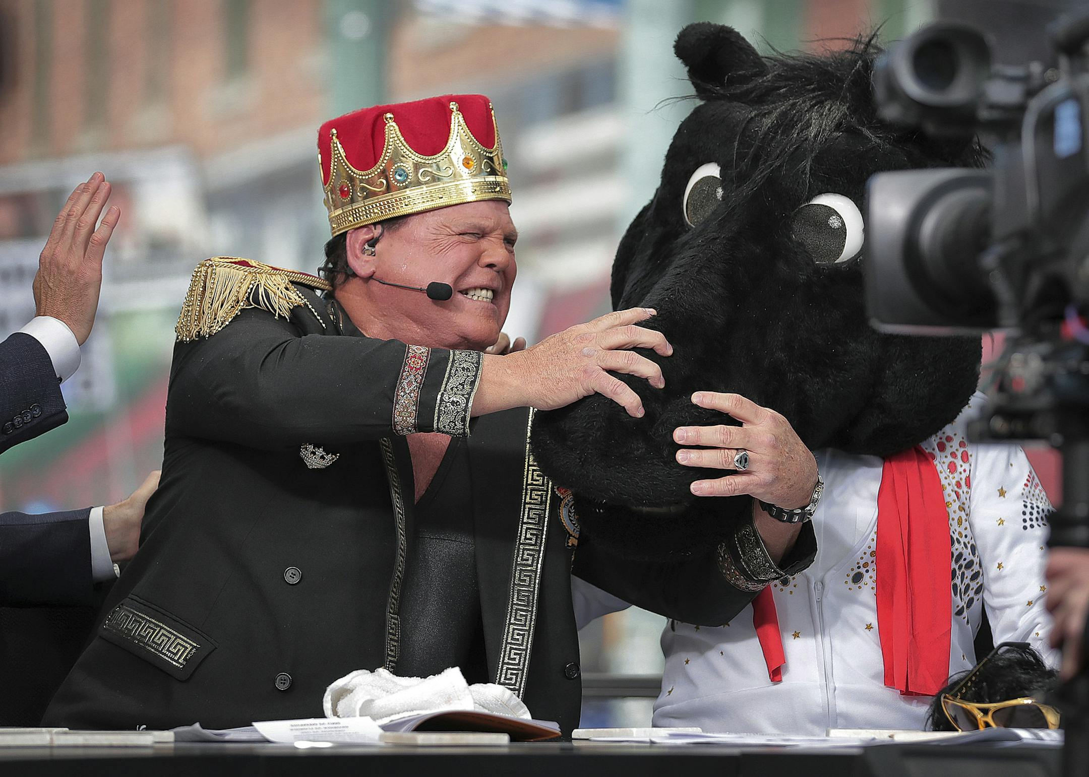 Pro wrestler Jerry (The King) Lawler reacts as ESPN's "College GameDay" host Lee Corso dons the mascot head of SMU, picking the Mustangs over the Memphis.