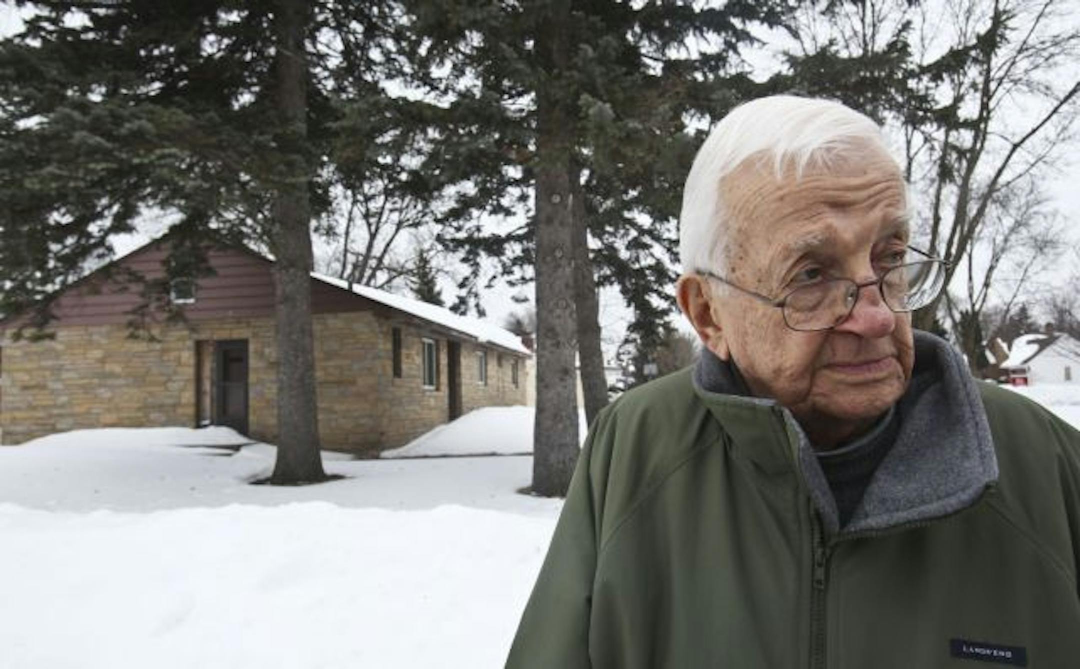 Bill Duddleston stood near a brick abandoned home on his block of Asbury Street in Falcon Heights. Duddleston and other neighbors have contacted city officials but nothing has been done since the house was left by the owner more than five years ago.