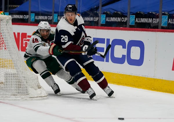 Minnesota Wild defenseman Jared Spurgeon (46) and Colorado Avalanche center Nathan MacKinnon (29) in the third period of an NHL hockey game Saturday, 