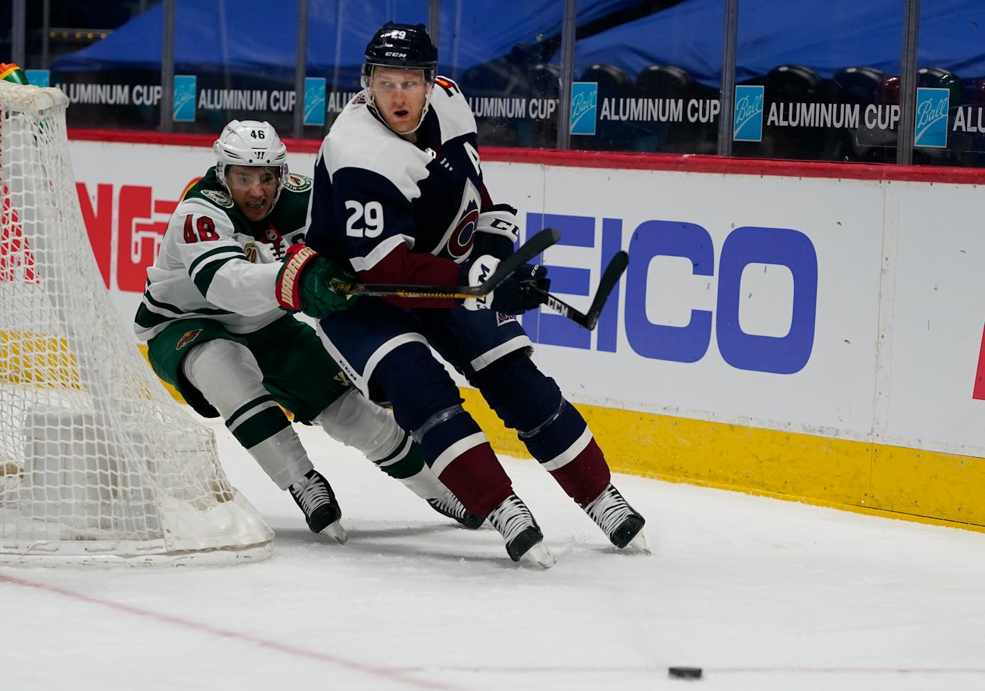 Minnesota Wild defenseman Jared Spurgeon (46) and Colorado Avalanche center Nathan MacKinnon (29) in the third period of an NHL hockey game Saturday, March 20, 2021, in Denver. The Avalanche won 6-0. (AP Photo/David Zalubowski)