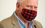 Gov. Tim Walz wore a buffalo plaid cloth mask during questions at Wednesday's news conference announcing a statewide mask mandate to help slow the spr