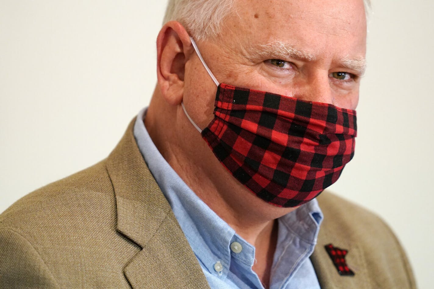 Gov. Tim Walz wore a buffalo plaid cloth mask during questions at Wednesday's news conference announcing a statewide mask mandate to help slow the spread of COVID-19.