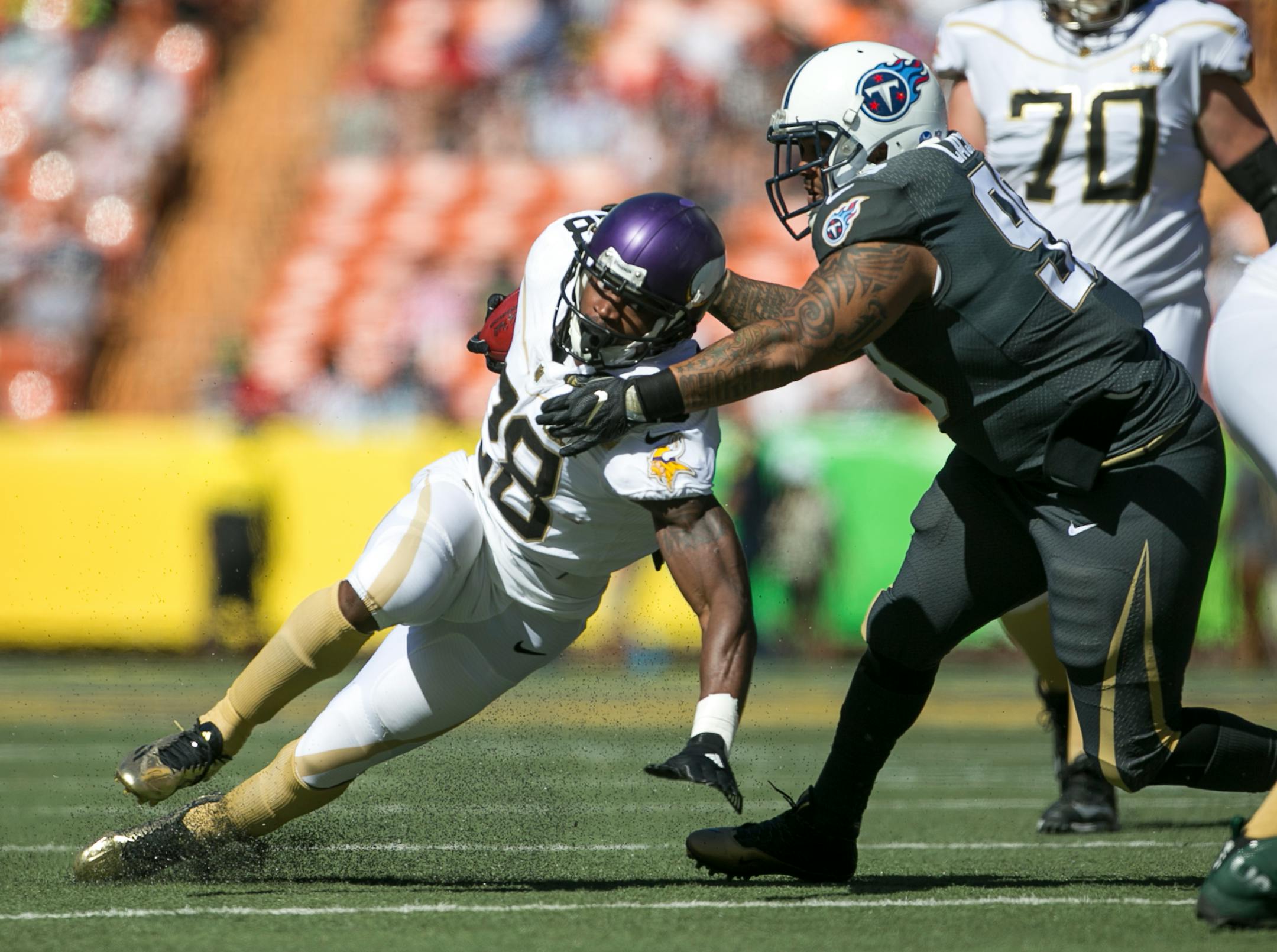 Tennessee Titans defensive tackle Jurrell Casey tried to pull down Vikings running back Adrian Peterson during the Pro Bowl. Peterson rushed five times for 4 yards and caught three passes for 20 yards.