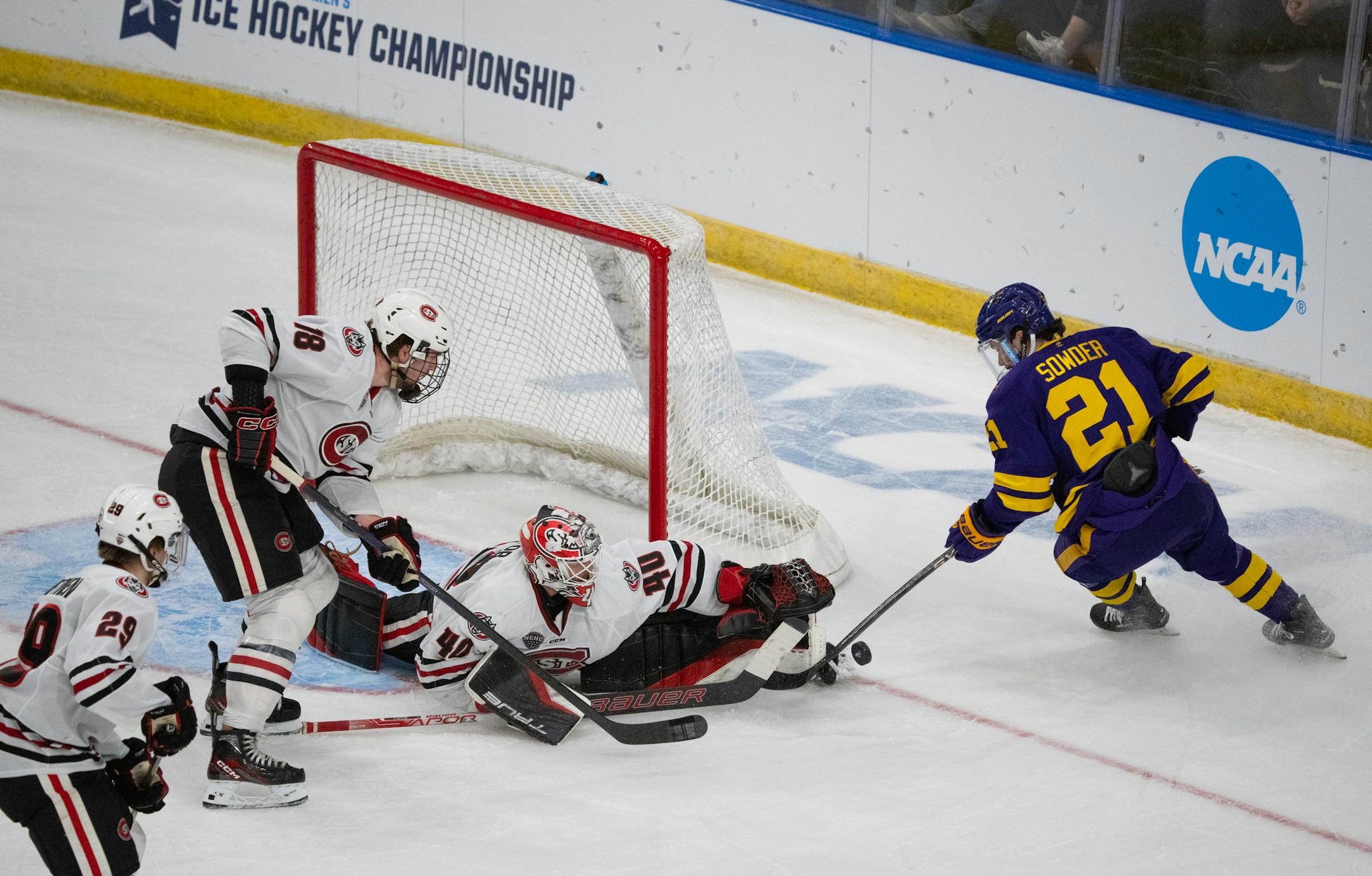 St. Cloud State Huskies goaltender Jaxon Castor (40) denied a shot by Minnesota State Mavericks forward Lucas Sowder (21) in the first period while St. Cloud State Huskies defenseman Brendan Bushy (18) moved in for the loose puck.