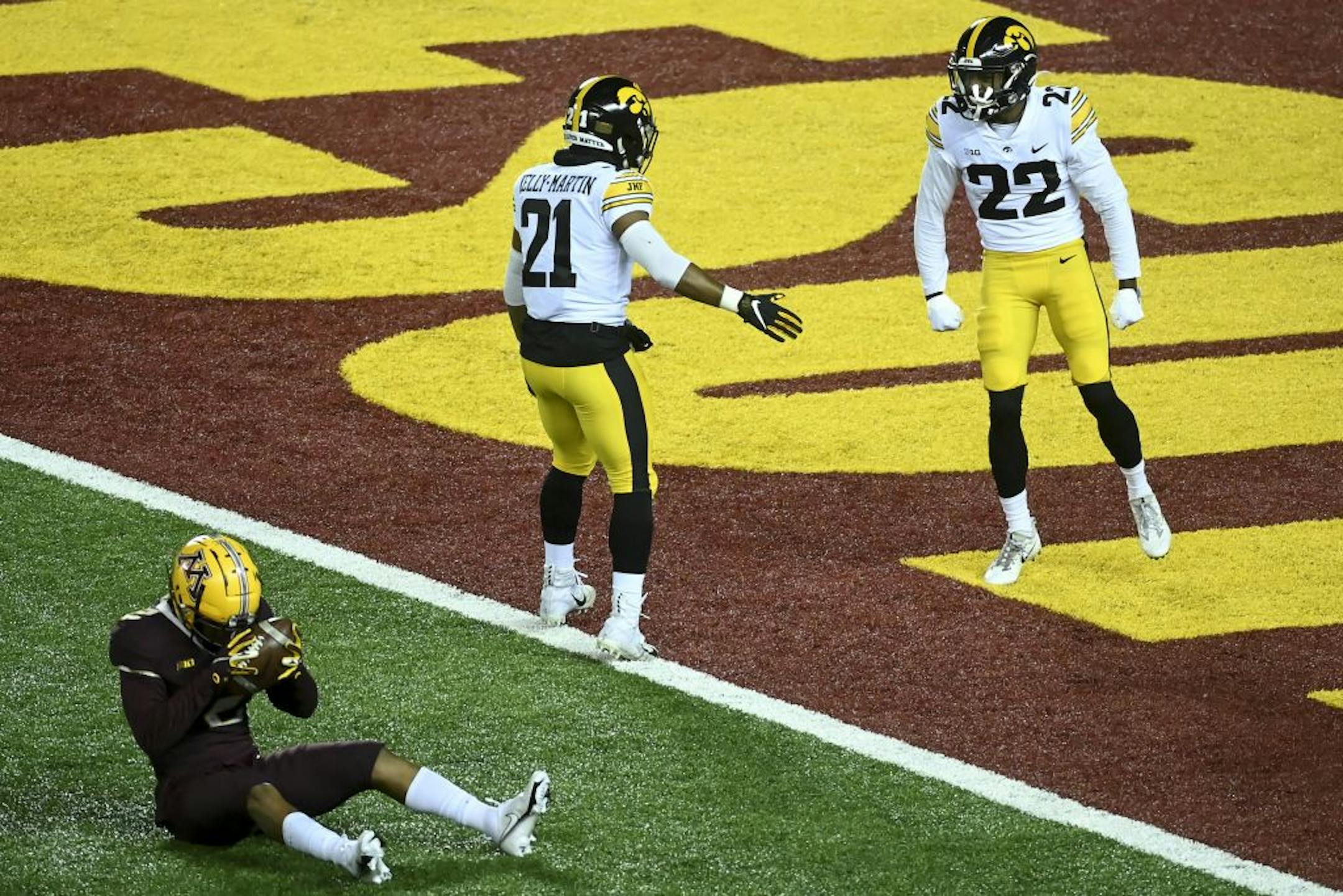 Minnesota Gophers defensive back Phillip Howard (2) was frustrated after being tackled at Iowa's 2-yard line by defensive back Terry Roberts (22) during a first quarter kickoff.