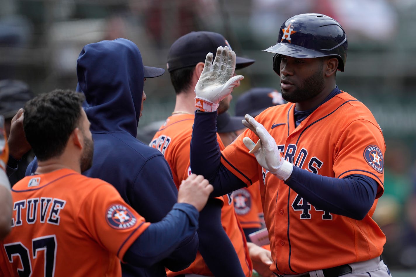 Houston Astros' Yordan Alvarez, right, is congratulated by teammates after hitting a home run during the ninth inning of a baseball game against the Oakland Athletics in Oakland, Calif., Sunday, May 28, 2023. (AP Photo/Jeff Chiu)