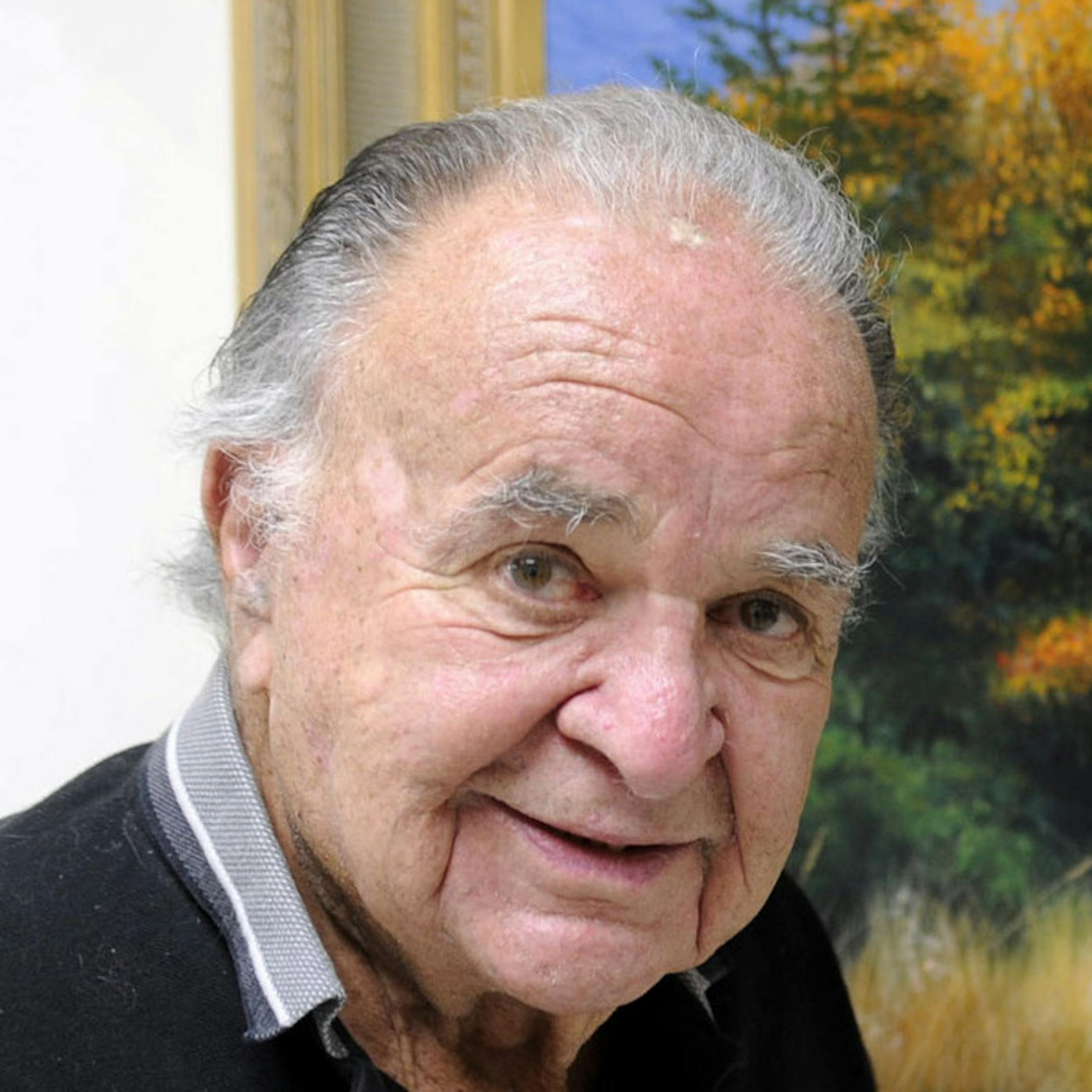 This June 2012 photo shows former ëMadí magazine editor Al Feldstein standing near one of his paintings at Livingston HealthCare. Feldstein, whose 28 years at the helm of Mad magazine transformed the satirical publication into a pop culture institution, has died, Tuesday, April 29, 2014. He was 88. (AP Photo/Livingston Enterprise, Aaric Bryan)