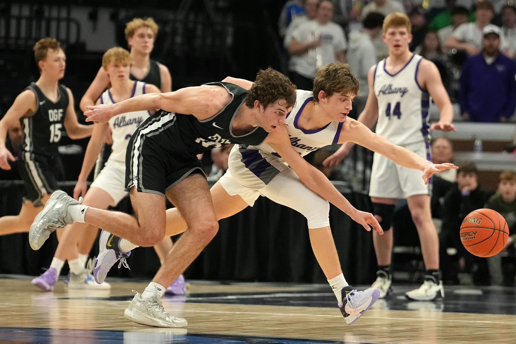 DGF guard Owen Leach (10) and Albany guard Tysen Gerads (22) race for a loose ball in the first half.