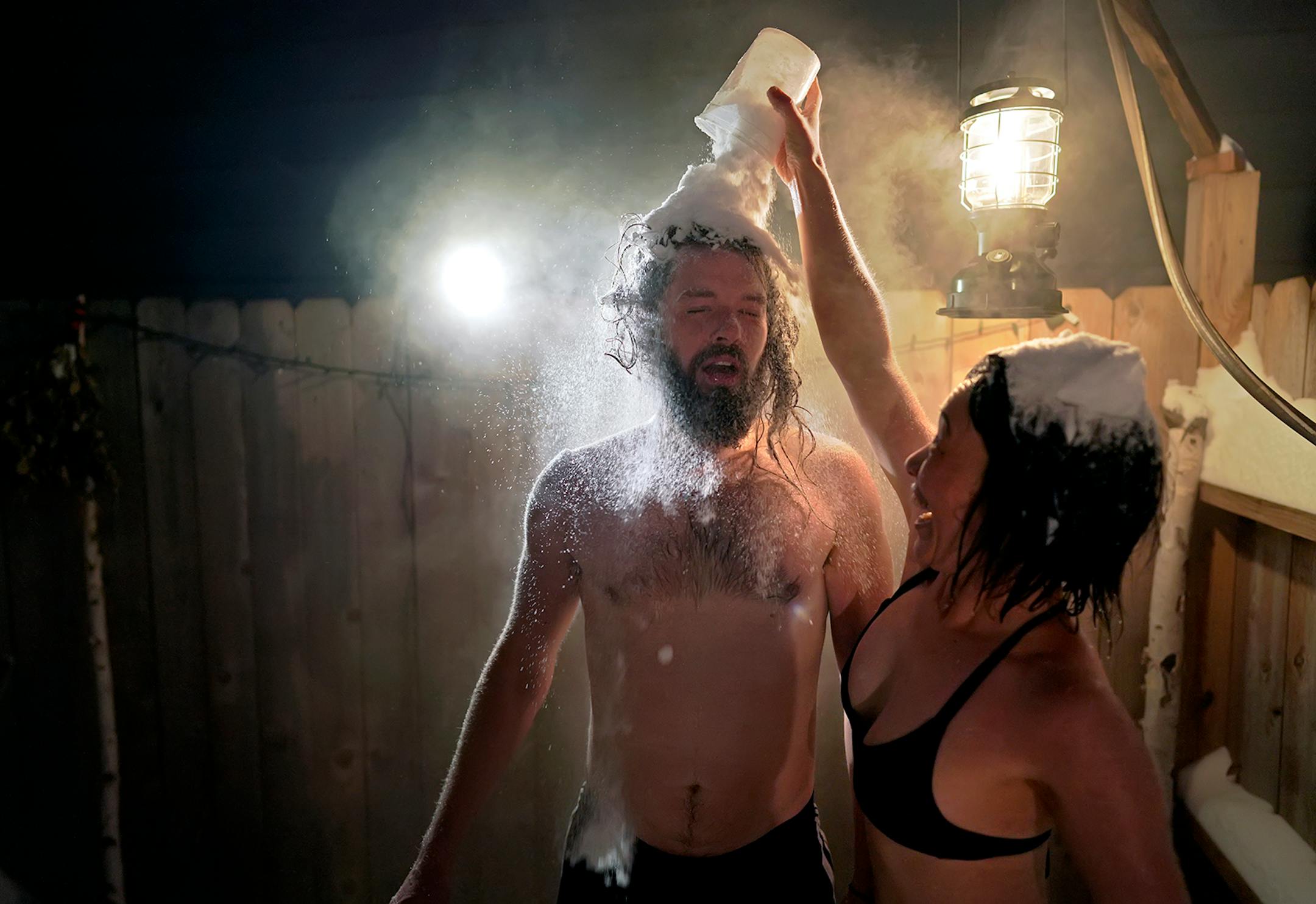 As temperatures dipped into the minus 20 degree range with a -42 windchill, Glenn and Julia Auerbach invited their friends Dan Wilson and Omina Shibahara over to their south Minneapolis home for a backyard sauna on January 29, 2019. Here, Shibahara gives Wilson a cool down cup of snow over the head. The hot room was 200 degrees and the air temp was 220 degrees colder at minus 20.