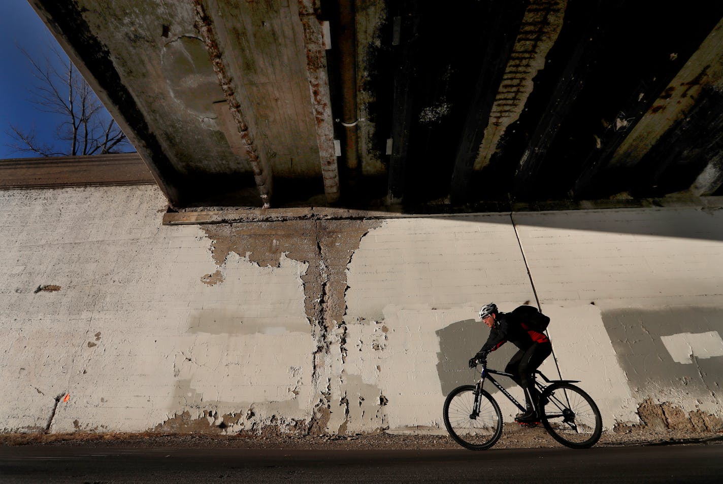 A cyclist riding on the Midtown Greenway passed under the Portland Avenue Bridge in Minneapolis. ] CARLOS GONZALEZ � cgonzalez@startribune.com - February 14, 2017, Minneapolis, MN, Two major roads through south Minneapolis will shut down this spring as Hennepin County continues to replace deteriorating historic bridges that cross the Midtown Greenway Corridor, Portland or Cedar bridges