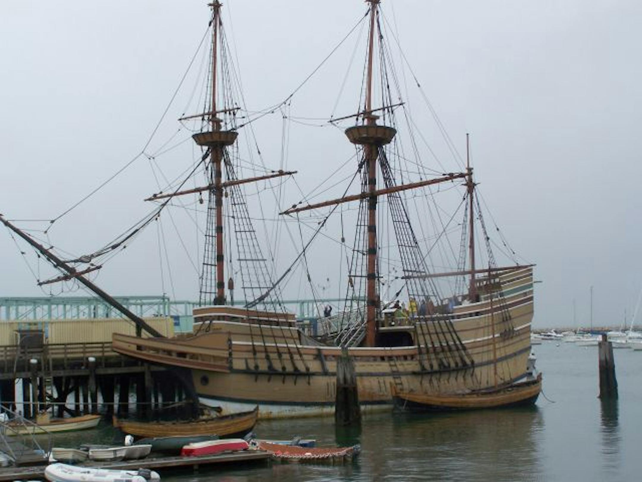 A replica of the ship that brought Pilgrims to the New World is anchored in downtown Plymouth, Mass., above. Plimoth Plantation works to re-create the "mother colony'' without the myths, from its buildings of rough construction, right, to the details of the personal histories of the original settlers.