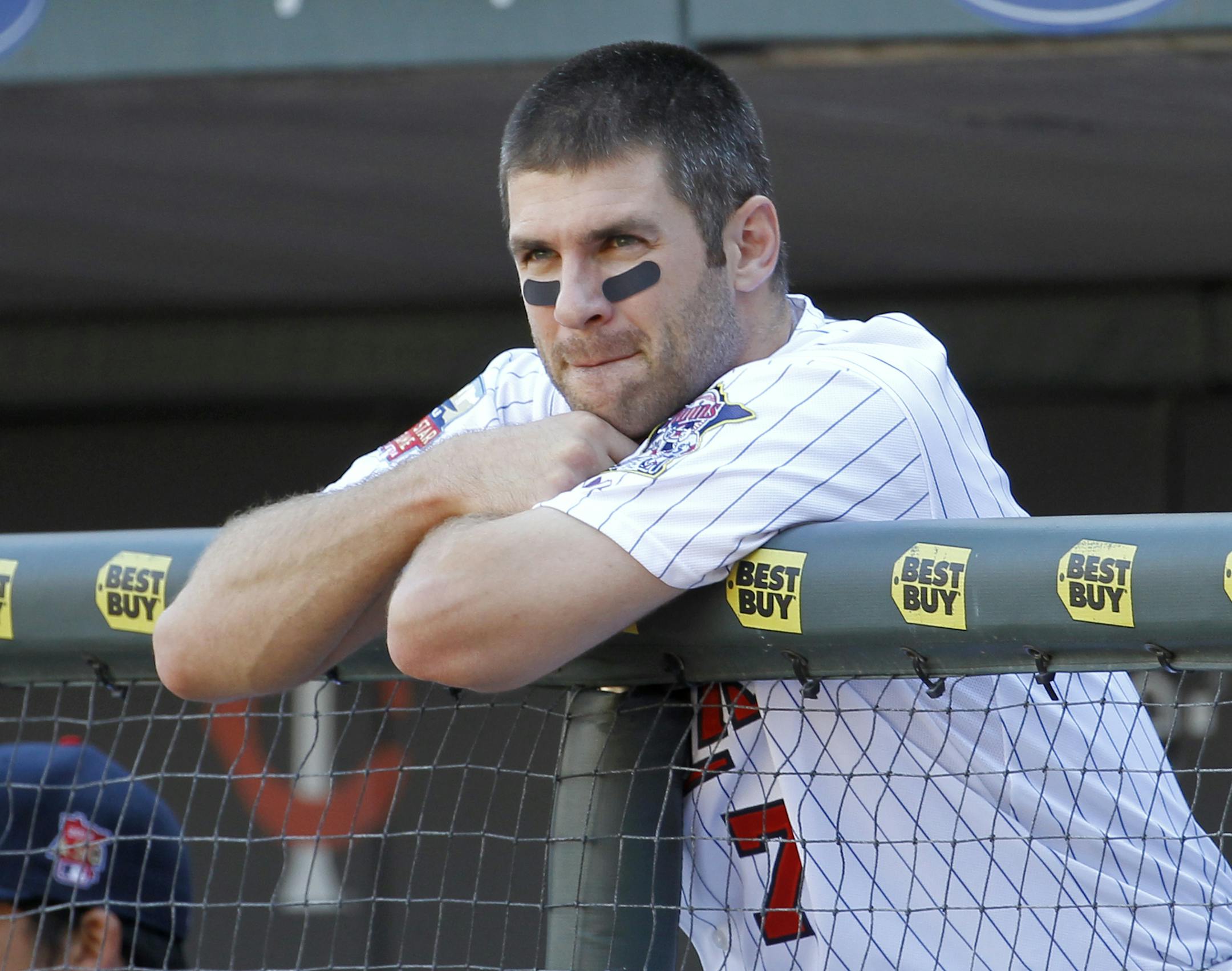 Minnesota Twins' Joe Mauer (7) looks out of the dugout during the sixth inning of a baseball game against the Los Angeles Angels in Minneapolis, Sunday, Sept. 7, 2014. The Angels won 14-4.(AP Photo/Ann Heisenfelt)