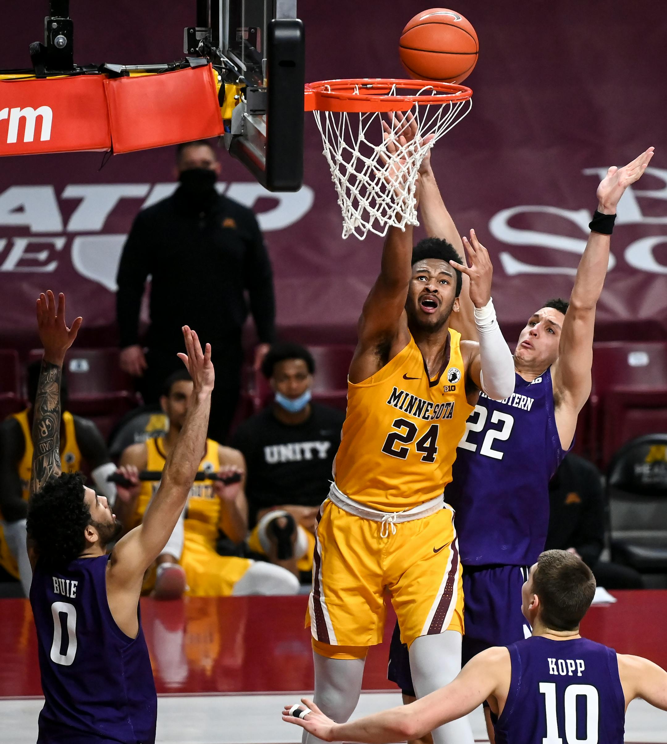 Minnesota Gophers forward Eric Curry (24) missed a shot as he was challenged by Northwestern Wildcats forward Pete Nance (22) below the rim.