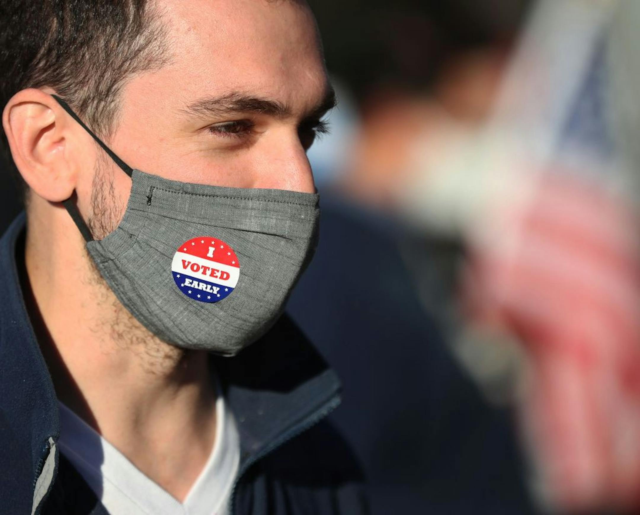 Jason Miller of Minneapolis, who was the first in line for early voting, wore a sticker after voting at Minneapolis Elections and Voter Services Friday in Minneapolis.