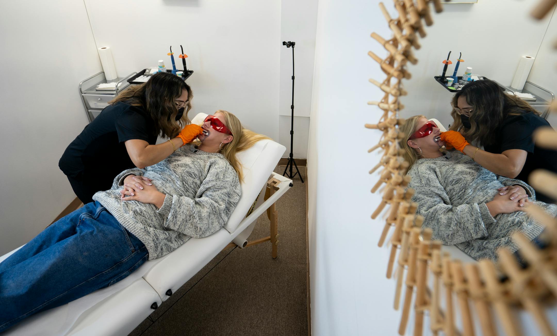 Mirna Lovo, owner of Pearly Whites MN, applies tooth gems to Josie Wicka, one of her most frequent clients, in Burnsville, Minn. on Thursday, June 29, 2023
