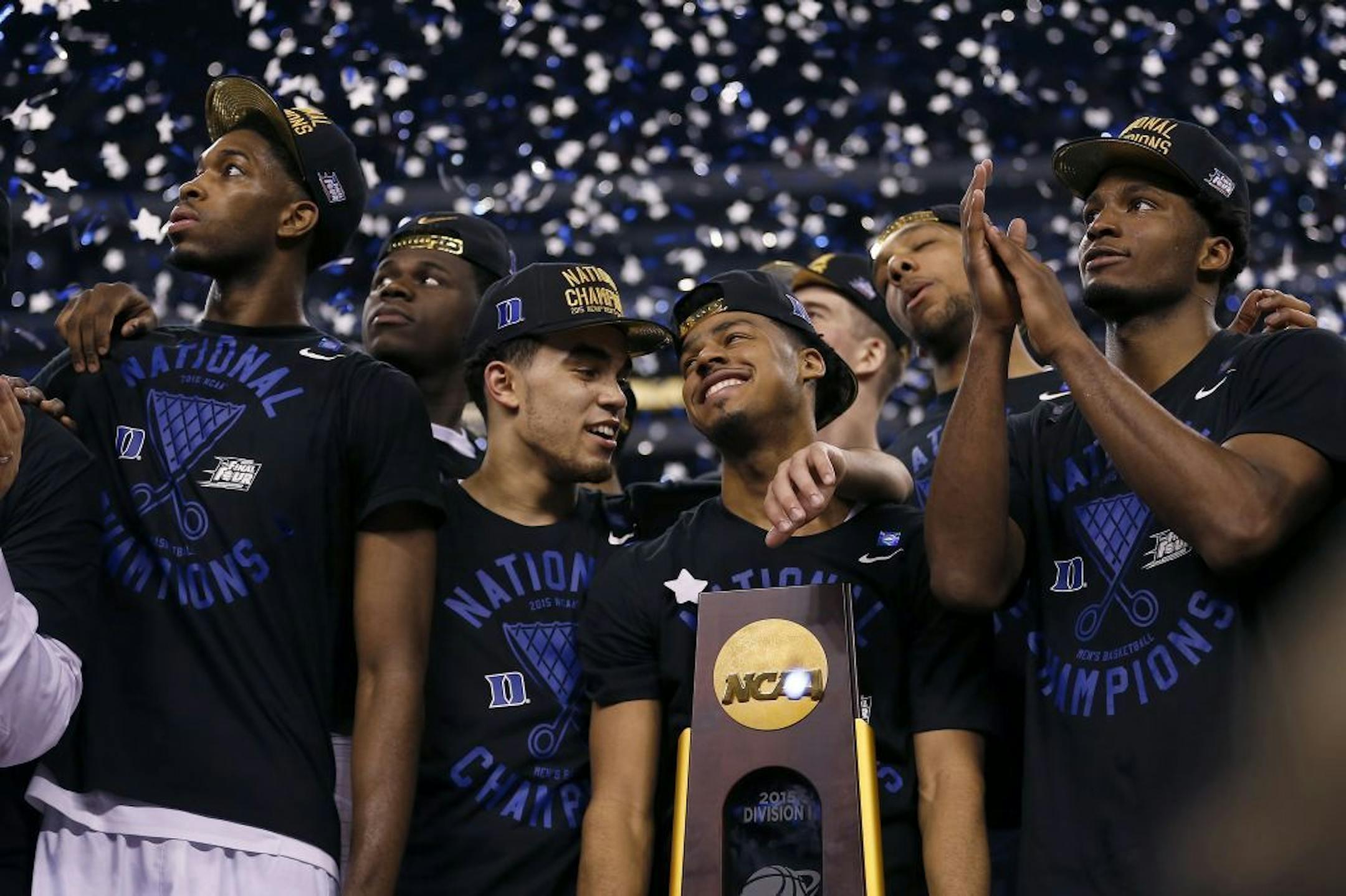 Duke Blue Devils guard Tyus Jones (5), center, and his teammates celebrate their 68-63 win over Wisconsin in the NCAA National Championship game on Monday, April 6, 2015, at Lucas Oil Stadium in Indianapolis.