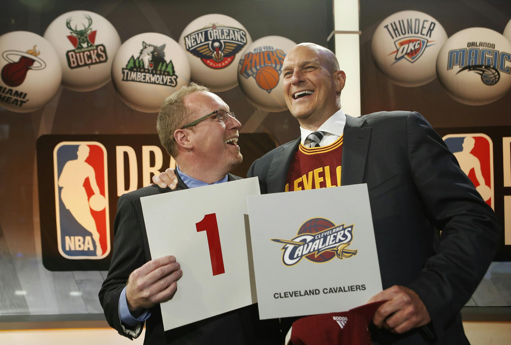 Cleveland Cavaliers general manager David Griffin, left, and minority owner Jeff Cohen celebrate after the Cavaliers won the top pick in the the NBA basketball draft lottery in New York, Tuesday, May 20, 2014. It's the third time in four years the Cavs will be atop the draft after moving up from the ninth spot. (AP Photo/Kathy Willens)