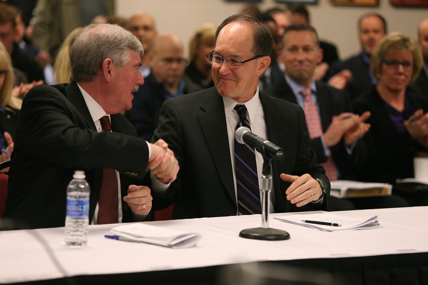 John Wood of Mortenson, left, and Steve Maki with the Minnesota Sports Facilities Authority, voted and agreed on a price of building a new Vikings stadium, Friday, November 22, 2013 at the Mall of America Field Halsey Room in Minneapolis.