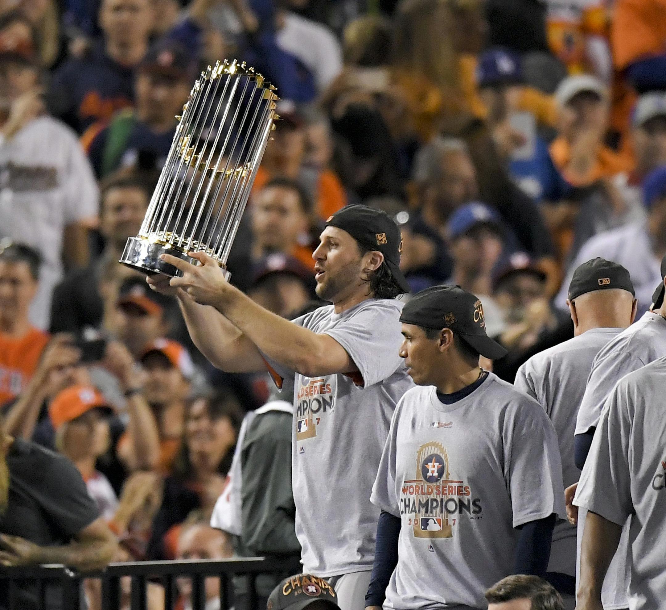 The Houston Astros celebrate with the trophy after their win against the Los Angeles Dodgers in Game 7 of baseball's World Series Wednesday, Nov. 1, 2017, in Los Angeles. The Astros won 5-1 to win the series 4-3. (AP Photo/Mark J. Terrill) ORG XMIT: WS475