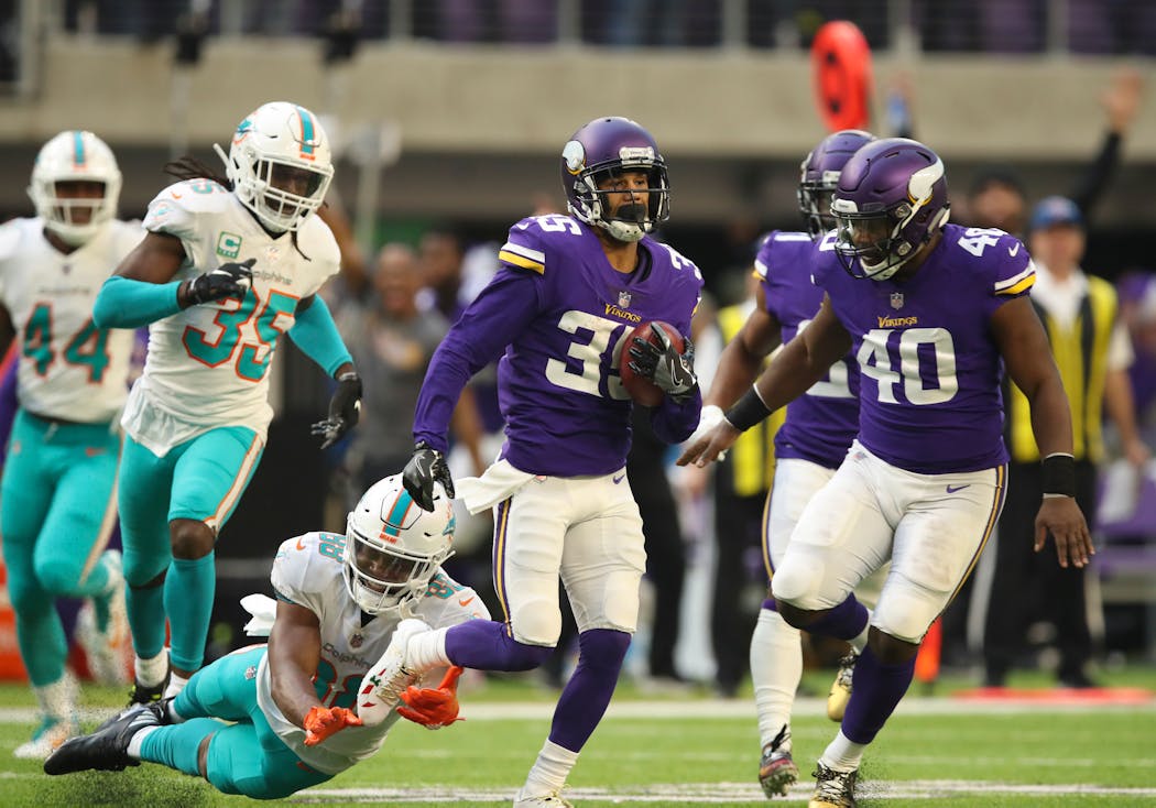 Marcus Sherels returned a third quarter punt for 70 yards before being tripped up by Dolphins wide receiver Leonte Carroo (88).