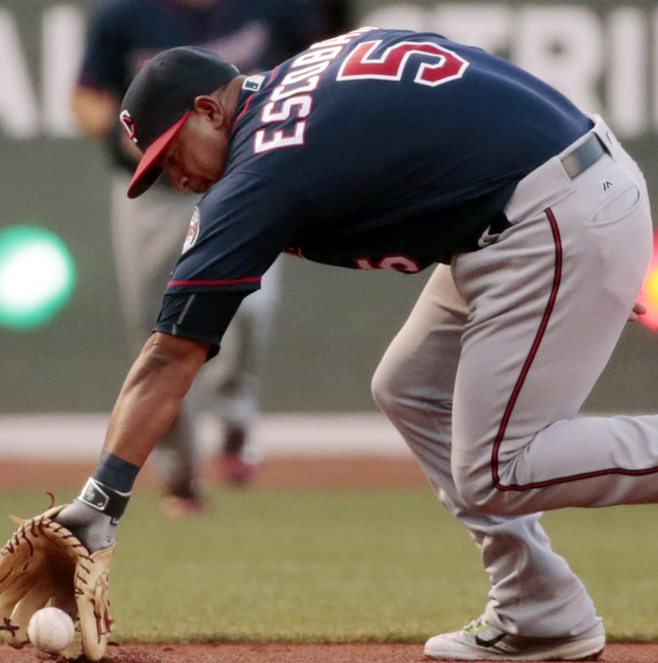 Minnesota Twins shortstop Eduardo Escobar fields a ground single by Boston Red Sox's Xander Bogaerts in the first inning of a baseball game at Fenway Park, Friday, July 22, 2016, in Boston. (AP Photo/Elise Amendola)