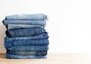 Beauty and fashion, clothing concept - stack of jeans.