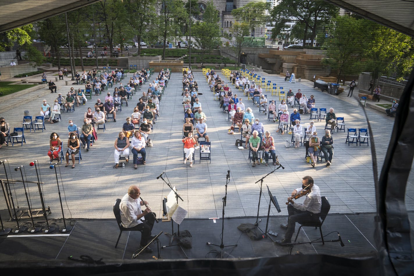 Minnesota Orchestra oboist John Snow and violinist Peter McGuire played an an outdoor concert in Peavey Plaza last month. LEILA NAVIDI • leila.navidi@startribune.com