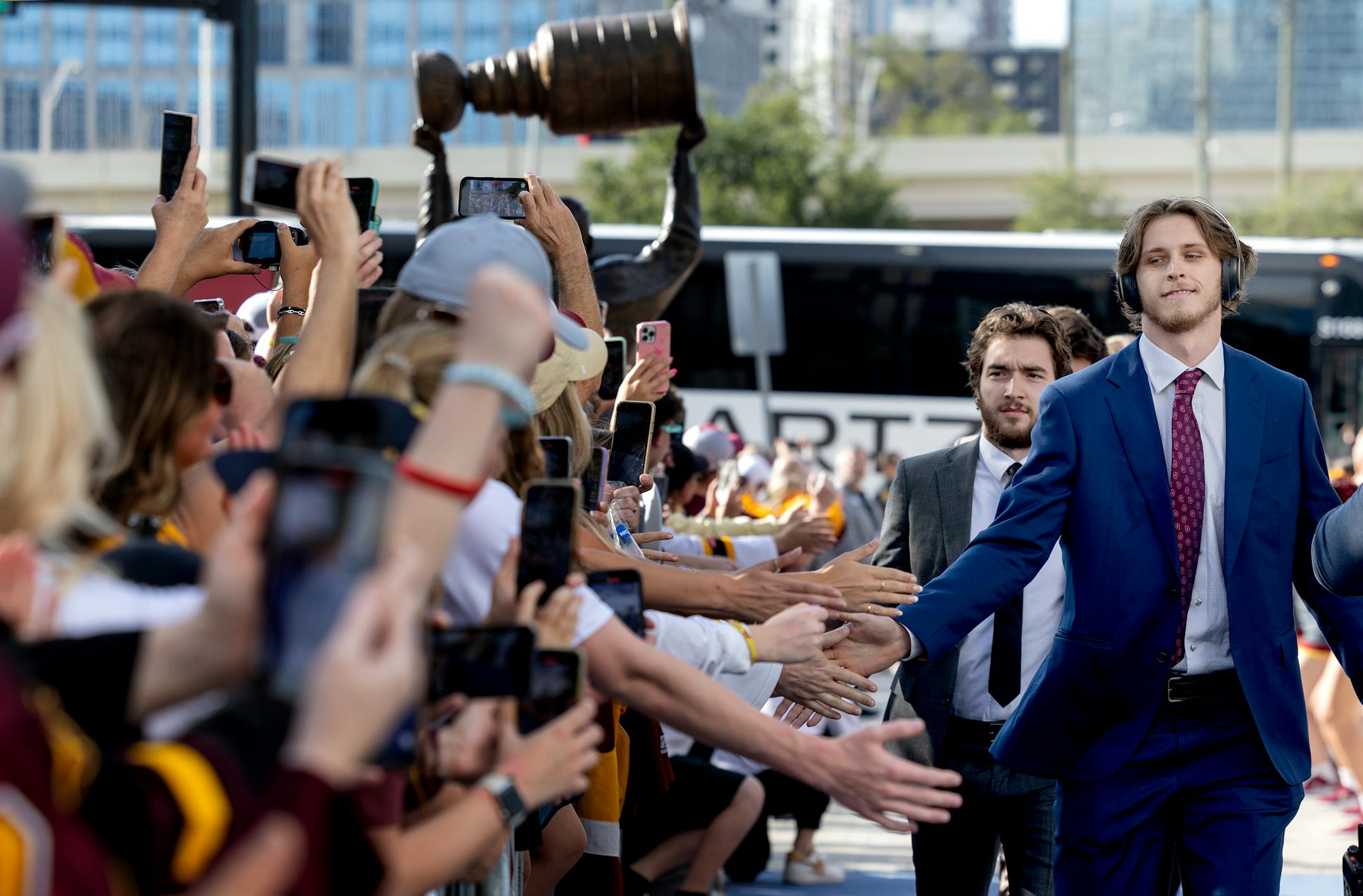 Minnesota Gophers players are greeted by fans as they arrive.