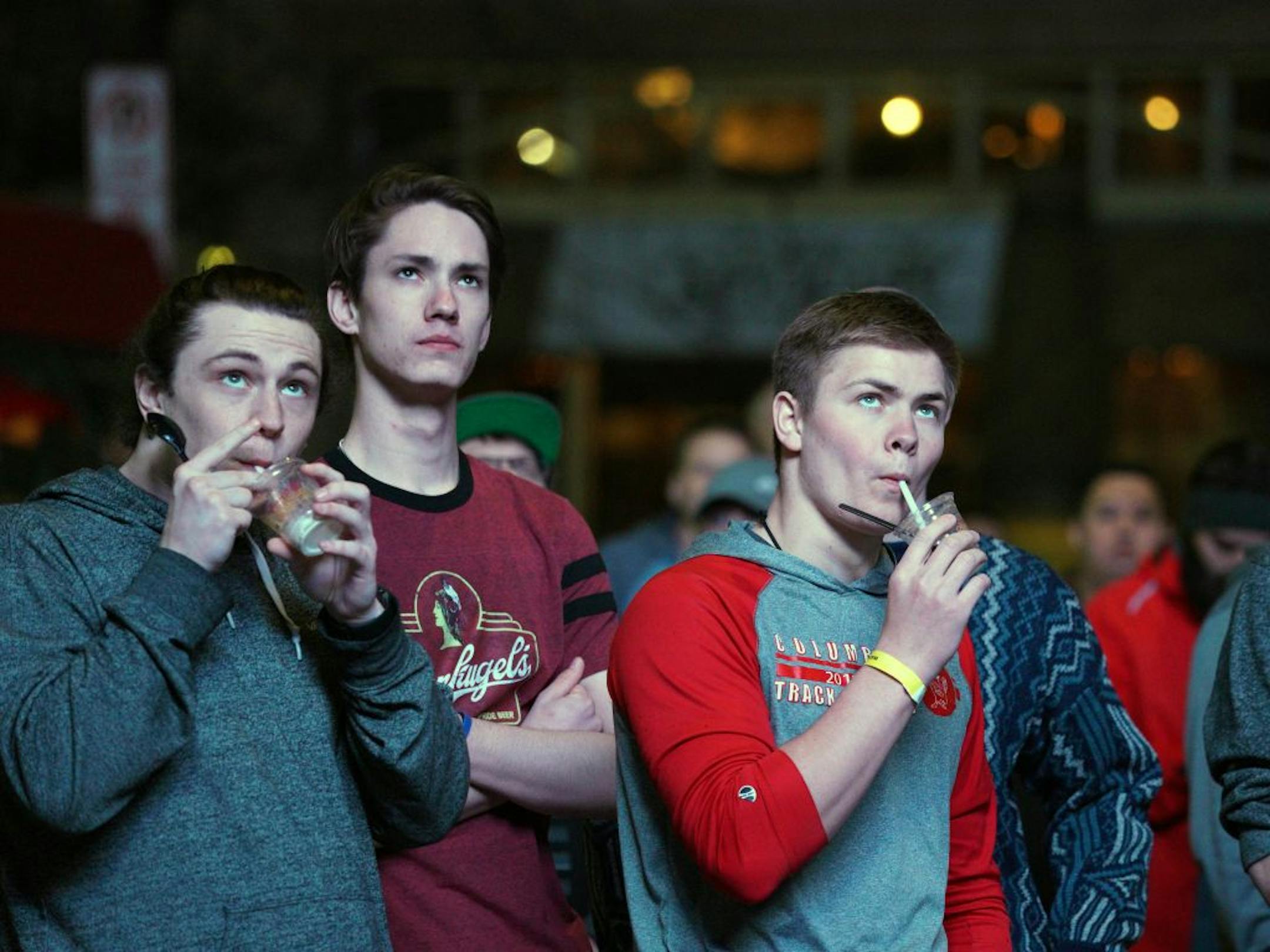 Fans sip cocktails while watching the NCAA men's basketball tournament championship game Monday night from Nicollet Mall.