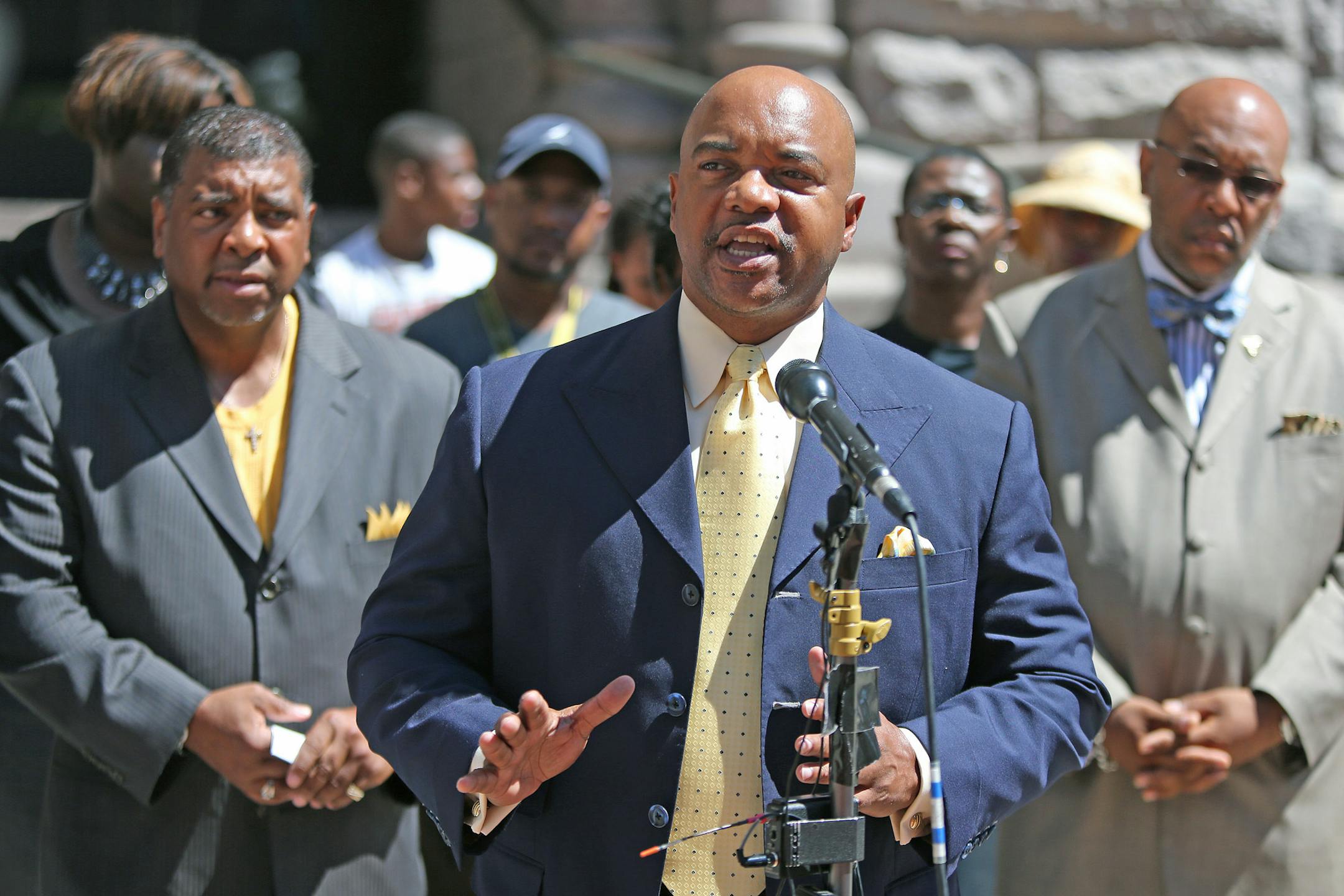 Community activists including Pastor Jerry McAfee, center, gathered in front of Minneapolis City Hall on Wednesday, August 7, 2013, to demand police accountablity after a series of troubling racial incidents.