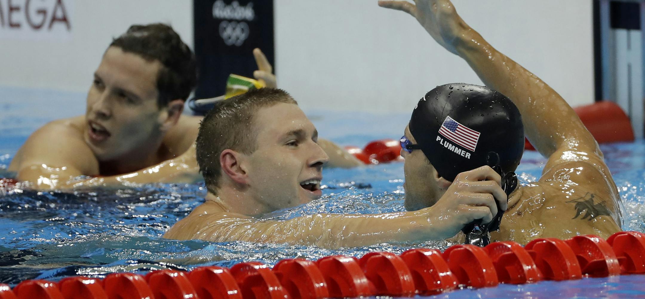 United States' Ryan Murphy, center, celebrates winning the gold medal in the men's 100-meter backstroke ahead of third placed United States' David Plummer during the swimming competitions at the 2016 Summer Olympics, Monday, Aug. 8, 2016, in Rio de Janeiro, Brazil. (AP Photo/Matt Slocum) ORG XMIT: OSWM256