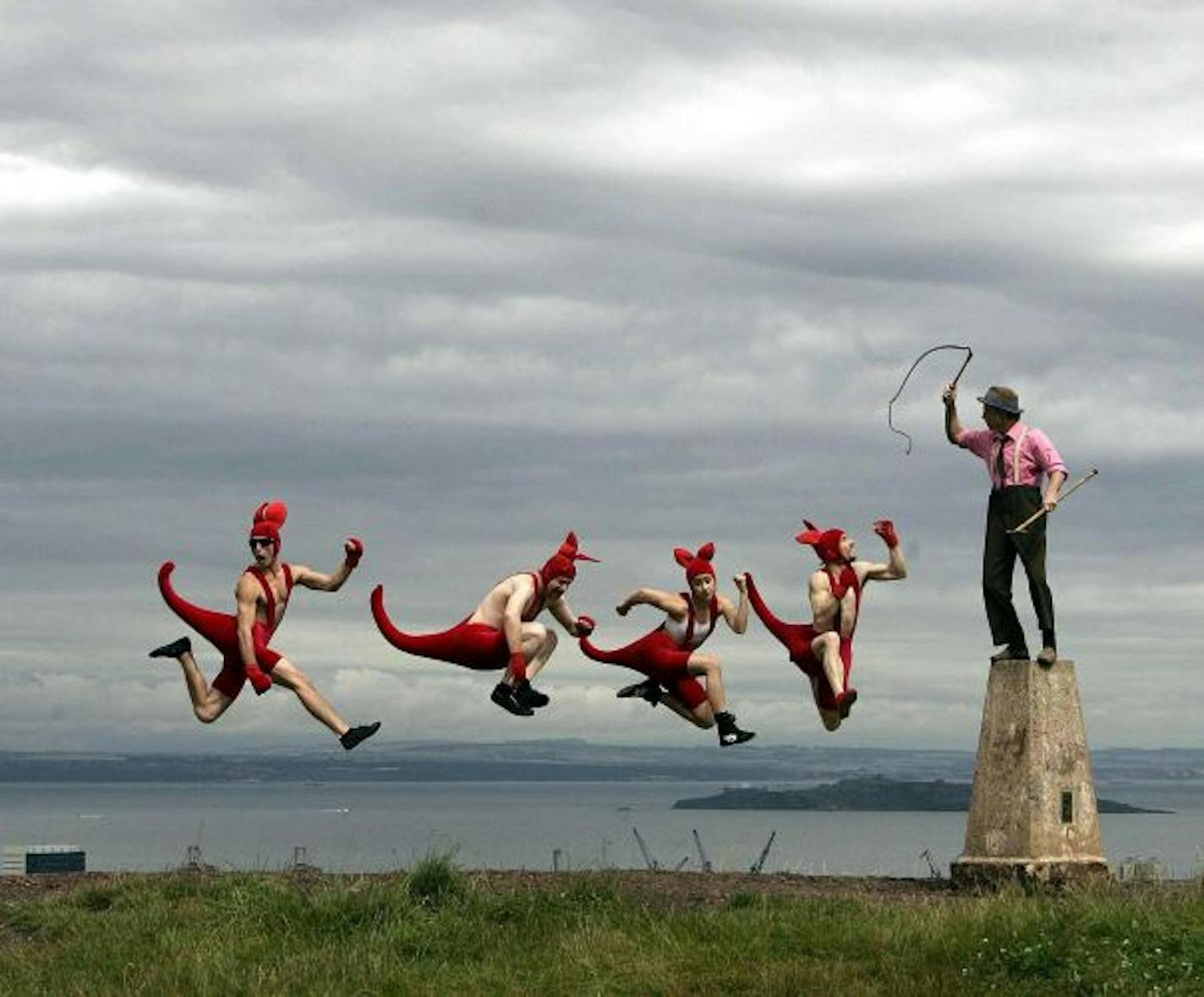 Circus Oz demonstrating part of their act on Calton hill in Edinburgh, ahead of the Edinburgh Arts Festival.