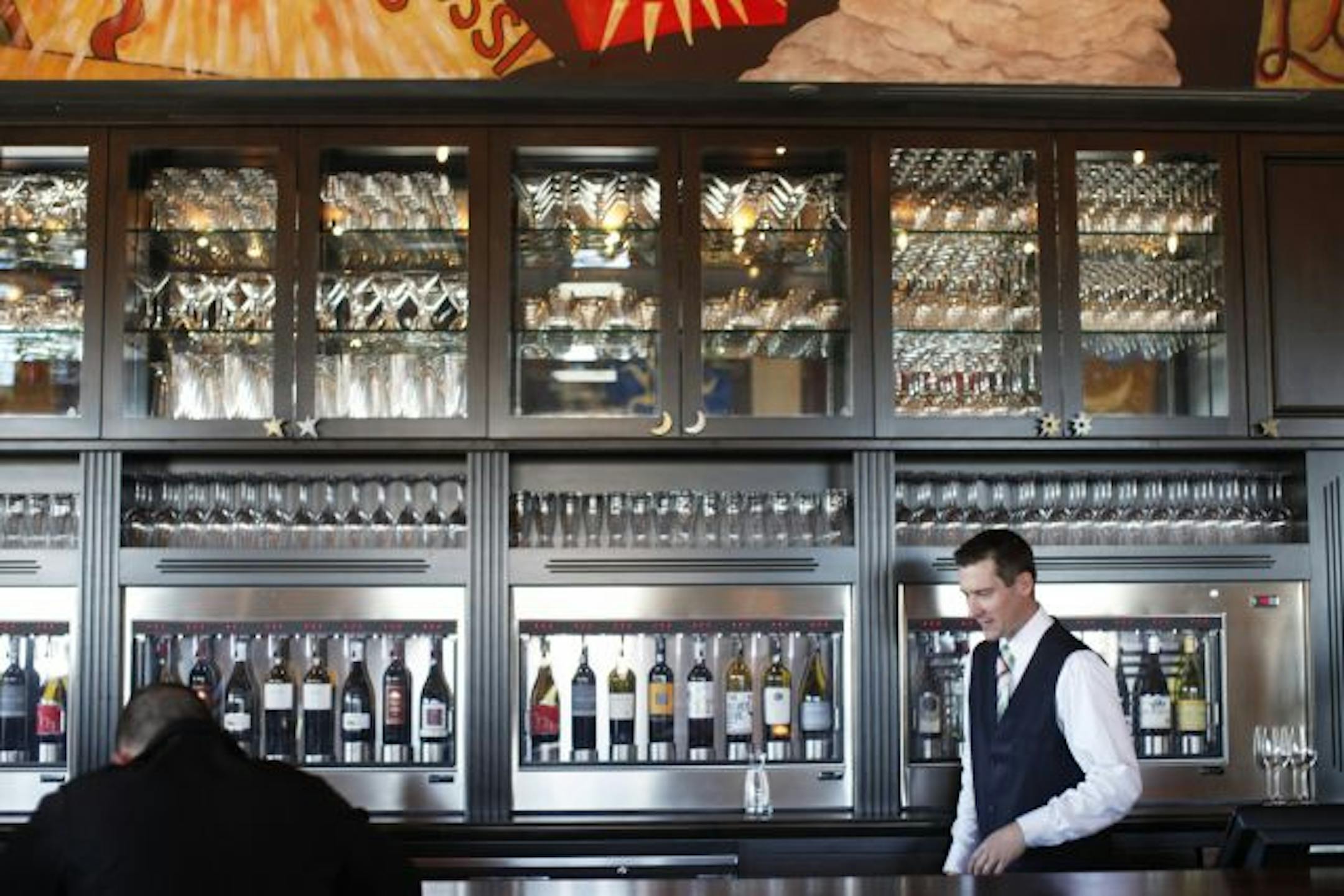 Bartender Dan Johnson behind the bar at Aperitif. The bar's Enomatic wine storage system can keep up to 40 open bottles of wine fresh up to six weeks.