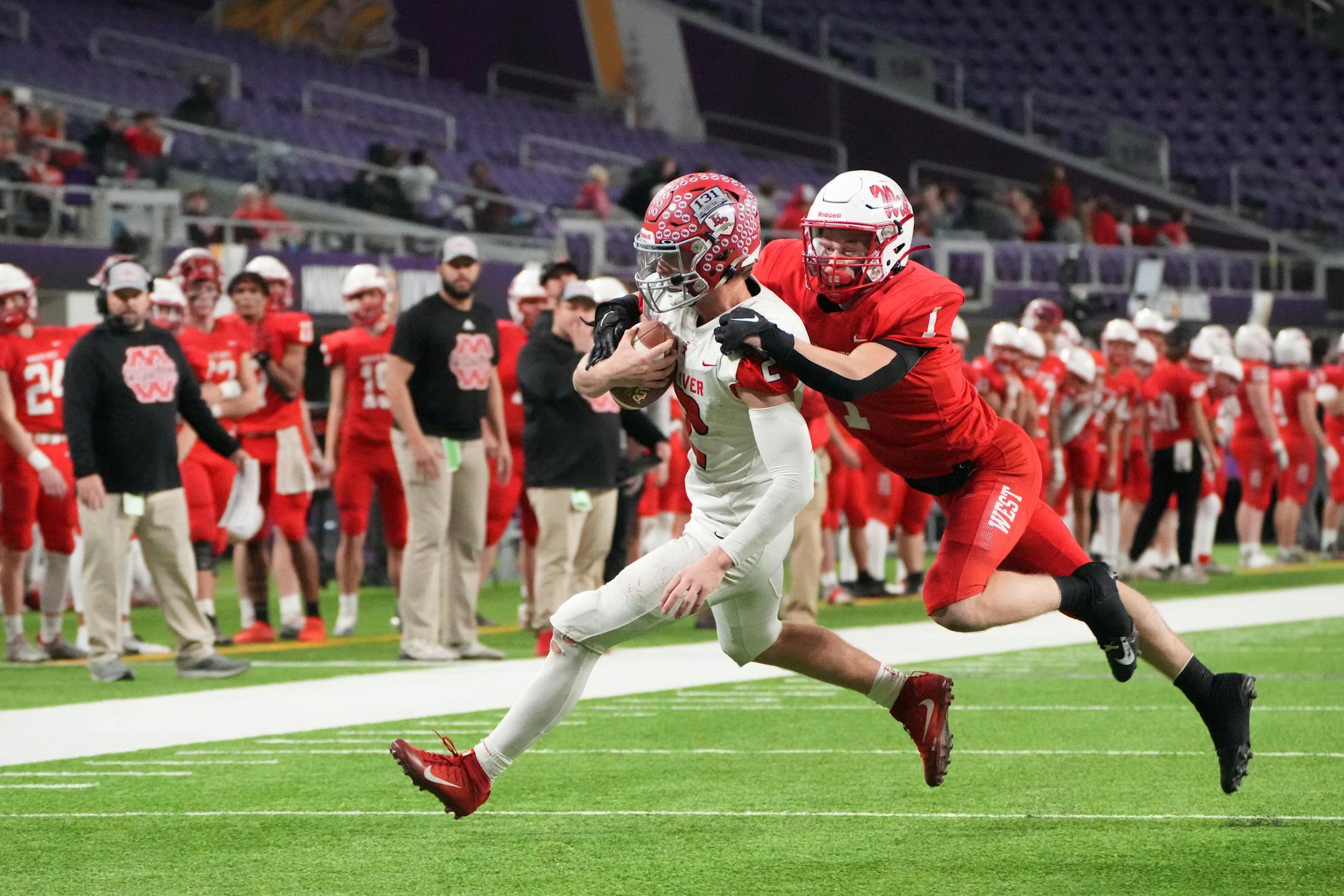 Elk River quarterback Cade Osterman (2) rumbles toward the endzone while carrying Mankato West's Damian Riewe (1) on his back in the second half of the Minnesota High School football Class 5A State Championship at U.S. Bank Stadium in Minneapolis, Minn., on Saturday, Dec. 3, 2022.