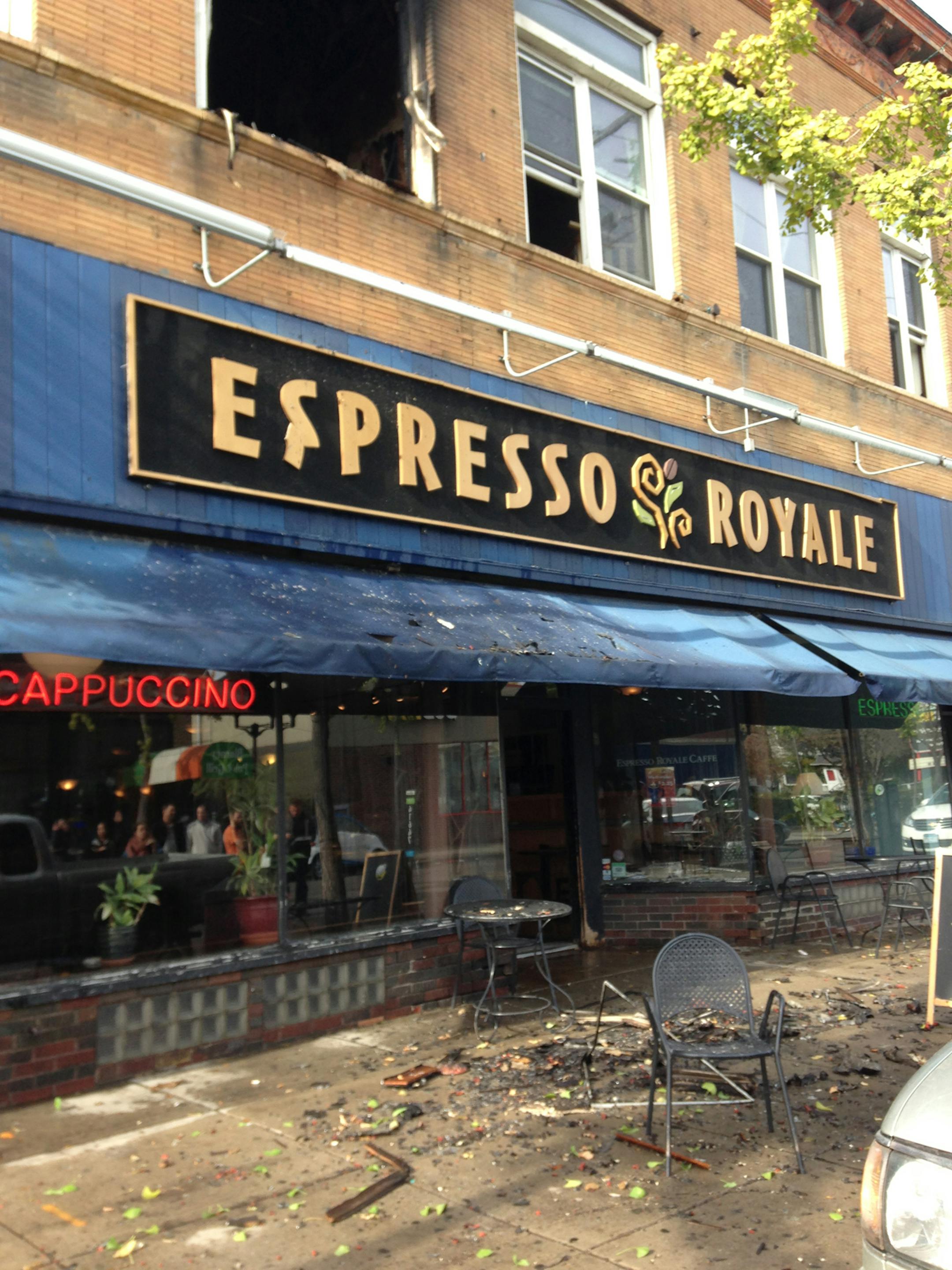 Smoke and water damage are visible outside Espresso Royale in the Dinkytown neighborhood near the University of Minnesota.