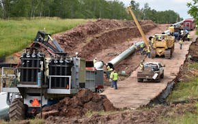 In this July 25, 2017, photo provided by Wisconsin Public Radio, crews begin work on the Wisconsin segment of Enbridge Energy's Line 3 near Superior, 