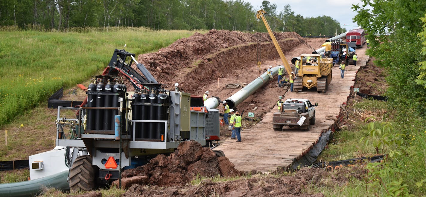 In this July 25, 2017, photo provided by Wisconsin Public Radio, crews begin work on the Wisconsin segment of Enbridge Energy's Line 3 near Superior, Wis. Six activists were arrested Tuesday, Aug. 29, for obstructing the work, and more protests are planned this weekend. (Elizabeth McMahon/Wisconsin Public Radio via AP)