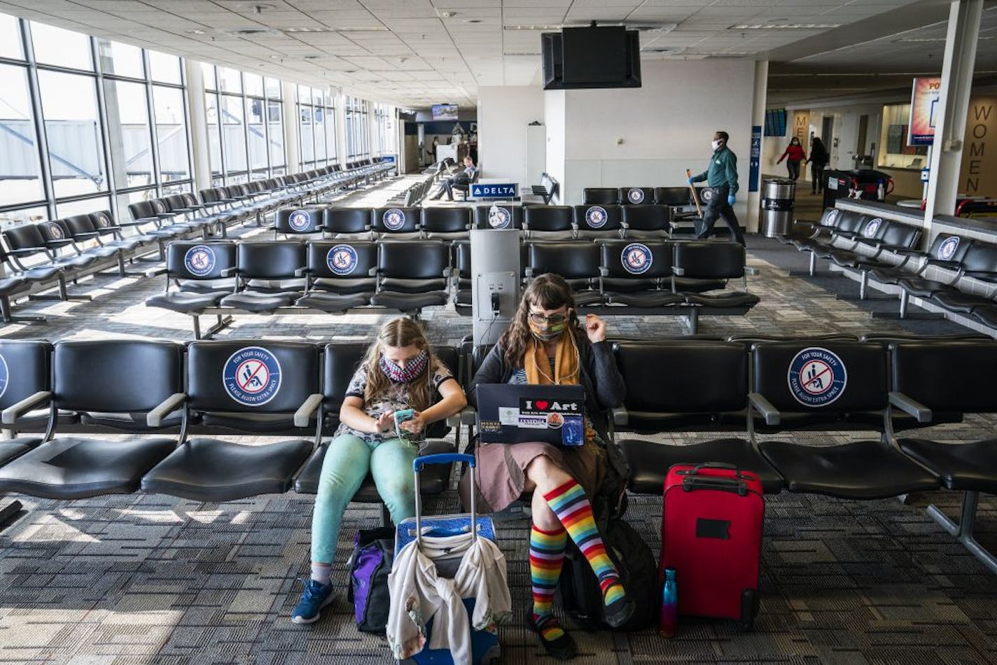 Mary Emma Heaps of Kalamazoo, Michigan waited for a flight with her daughter Mercy, 8, in Terminal 1 of Minneapolis - St. Paul International Airport.