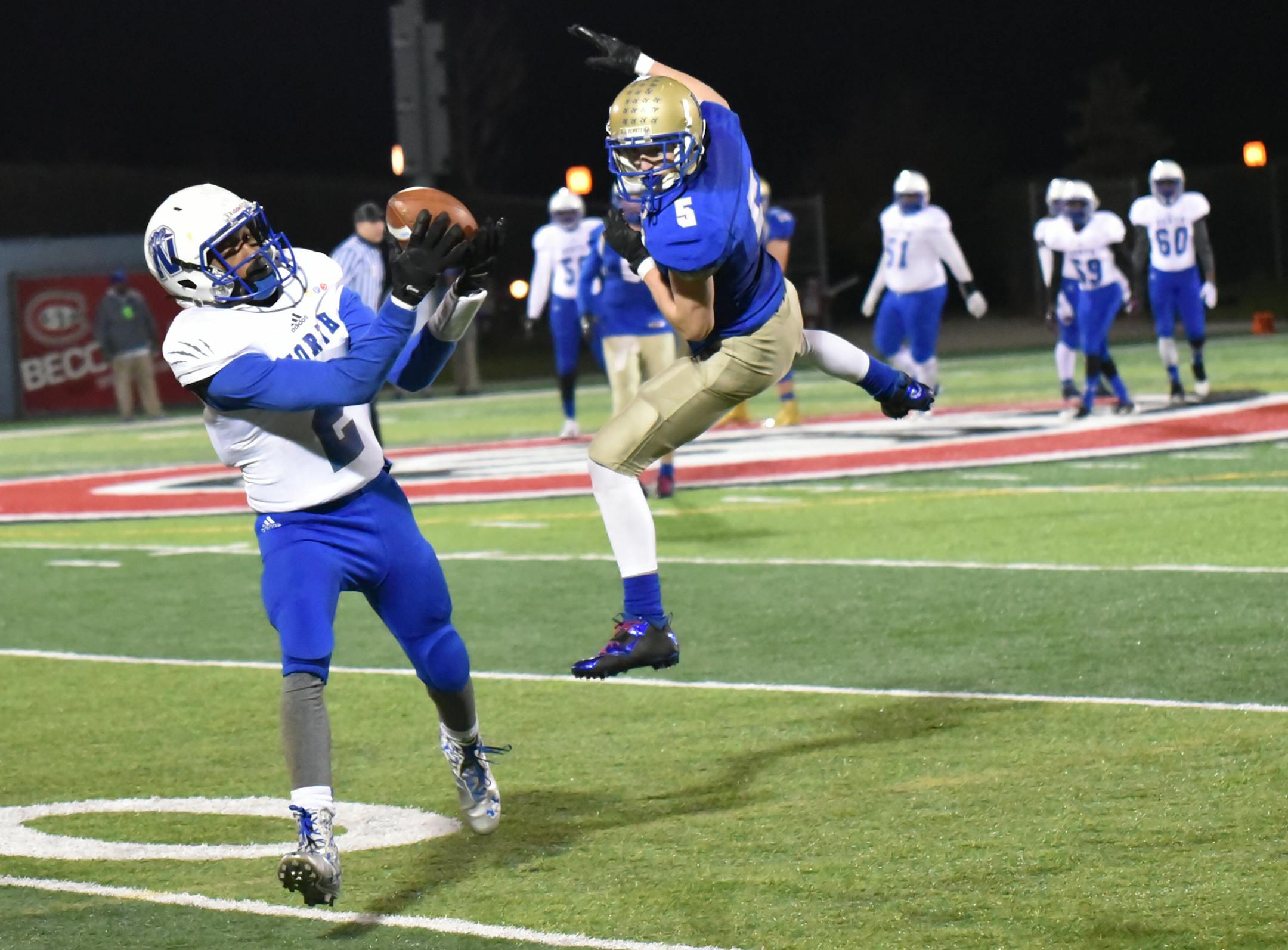North Polar Azerick Rodgers evades Braham's Wide Receiver Ryan Larson to score his first half touchdown in the Class A Semifinal game at St. Cloud State University. Minneapolis North leads the game 42-8 at the end of the first half. Photo by Kelly McGinley, mnfootballhub.