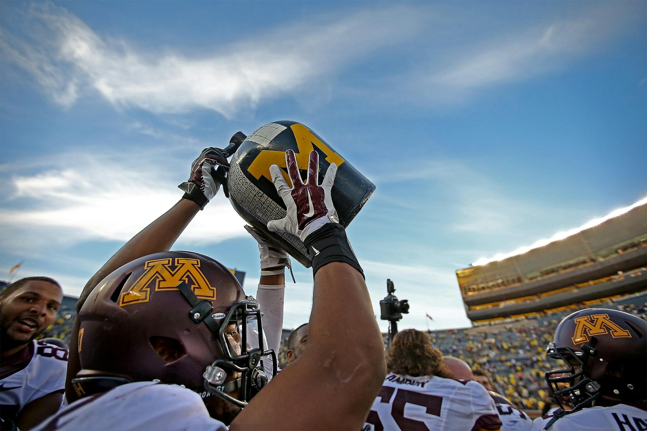 Minnesota running back David Cobb (27) grabbed the Little Brown Jug after helping defeat Michigan 30-14 at Michigan Stadium, Saturday, September 27, 2014 in Ann Arbor, MI.