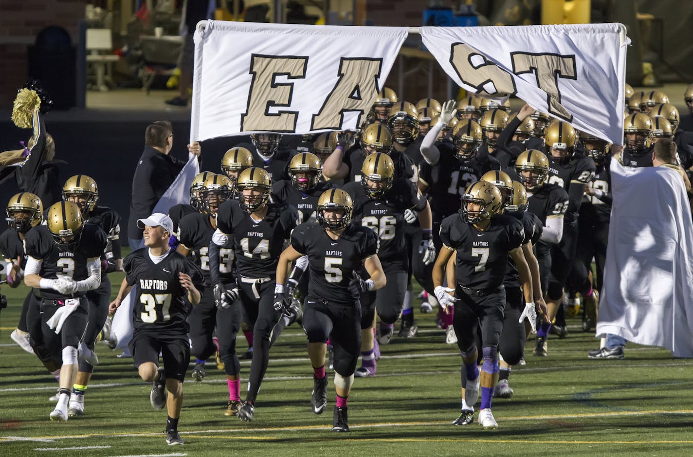 The East Ridge High School Raptors football team takes the field before playing rival Woodbury in 2015.