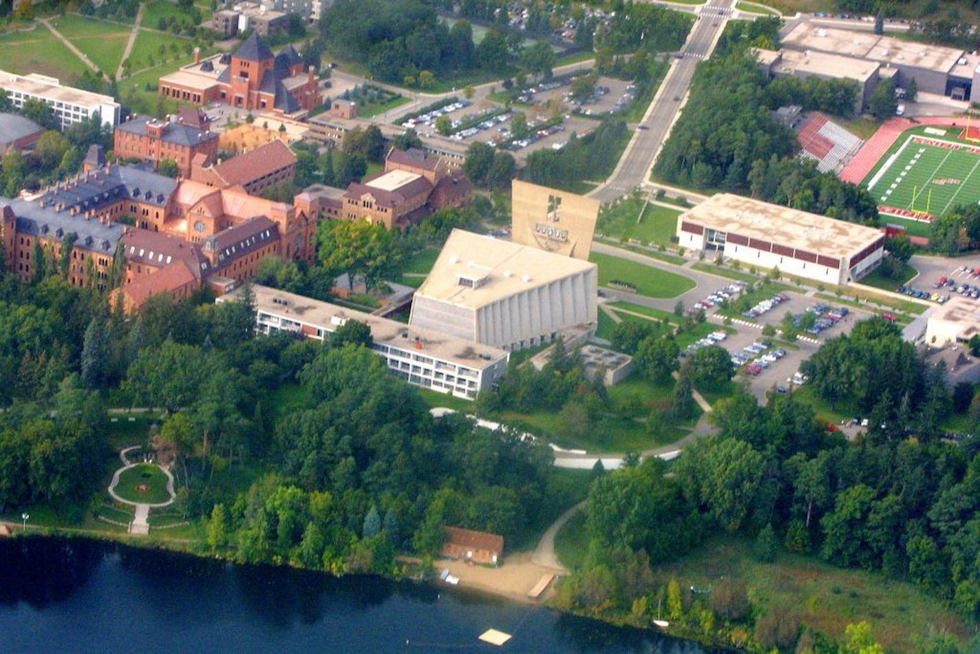 Aerial of campus, Abbey in center, old school at left, monestary attached to back of Abbey at center. Looking NW