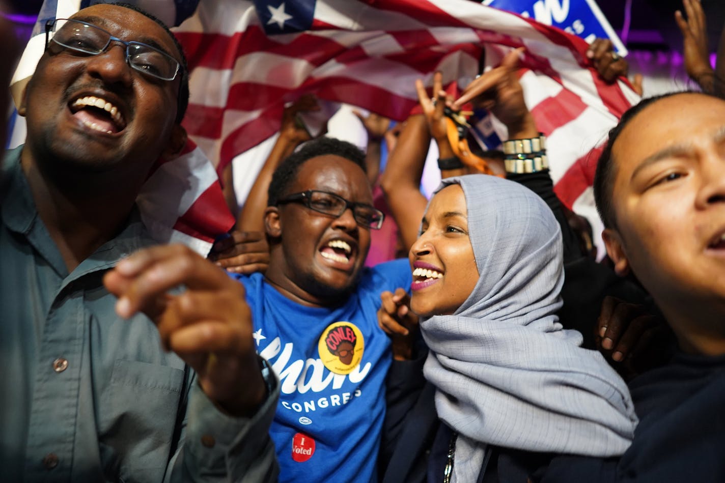 Minnesota Rep. Ilhan Omar, second from right, celebrates with her supporters after her Congressional 5th District primary victory, Tuesday, Aug. 14, 2018, in Minneapolis.