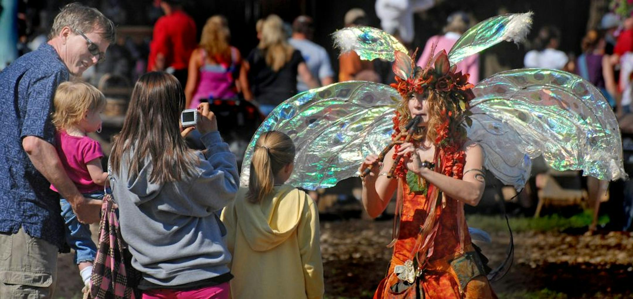 Shakope, Mn. Saturday 8/22/ The Minnesota Renaissance Fair opening day. Twig the fairy plays a tune on her flute on the opening day of the Minnesota Renaissance Fair.