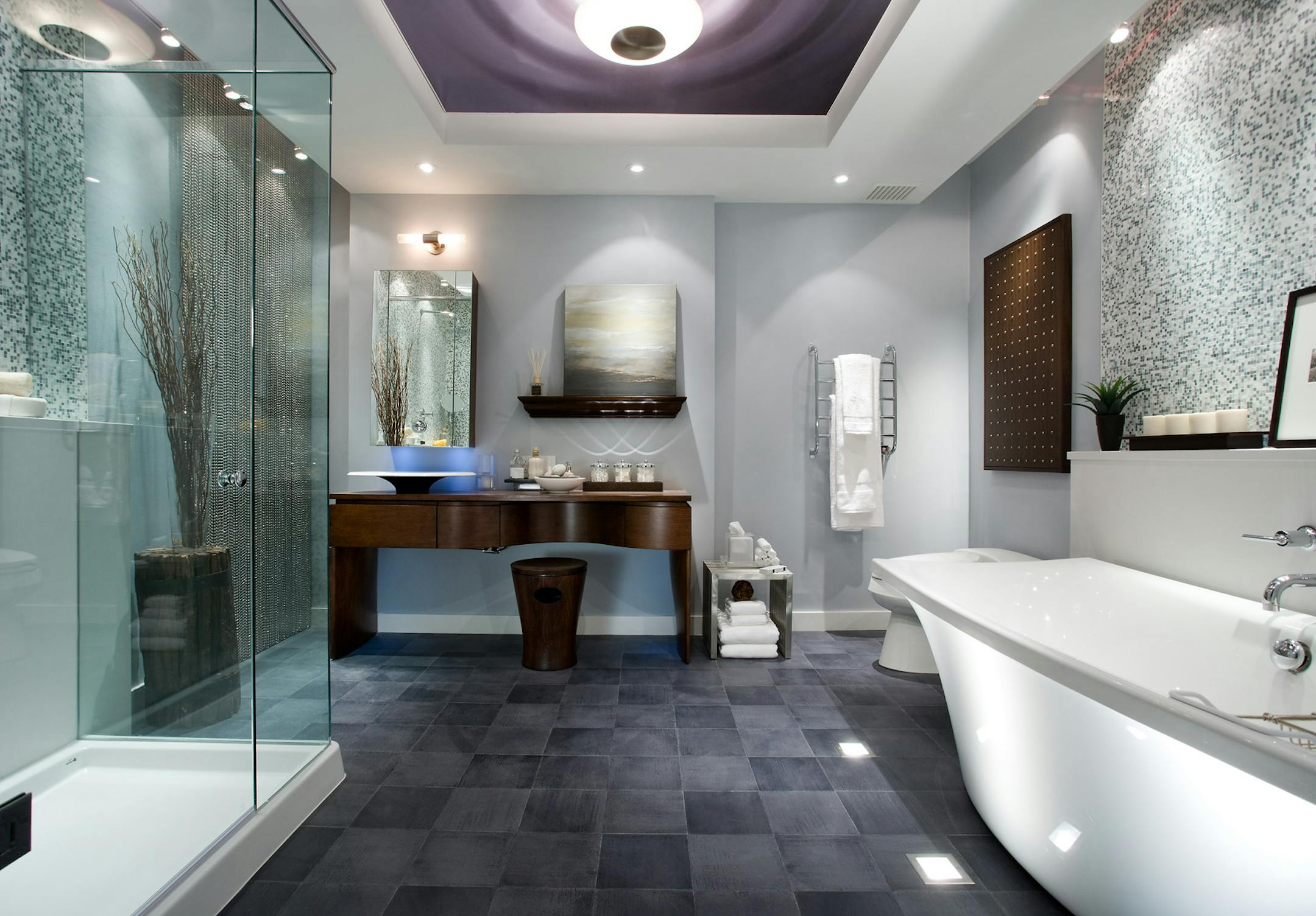 AFTER Luxurious finishes, fluffy towels, a dark walnut vanity and nature-inspired accents help balance the sleek feel of the enlarged bathroom. Another highlight: a ceiling mural of a water droplet.