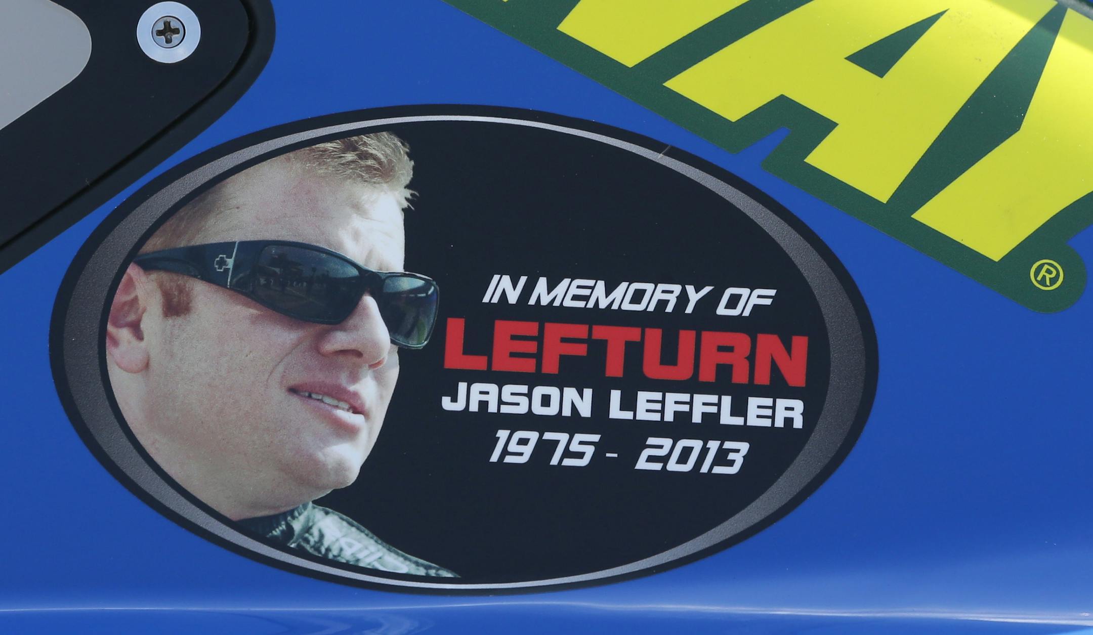 A Jason Leffler sticker is seen on Carl Edwards' car after qualifying, Friday, June 14, 2013 for Sunday's Quicken Loans 400 auto race at Michigan International Speedway in Brooklyn, Mich. The death of NASCAR driver Leffler at a dirt-track race near Philadelphia earlier this week has brought more attention to small, local tracks, where some big names like Tony Stewart still show up to race on occasion. (AP Photo/Carlos Osorio)