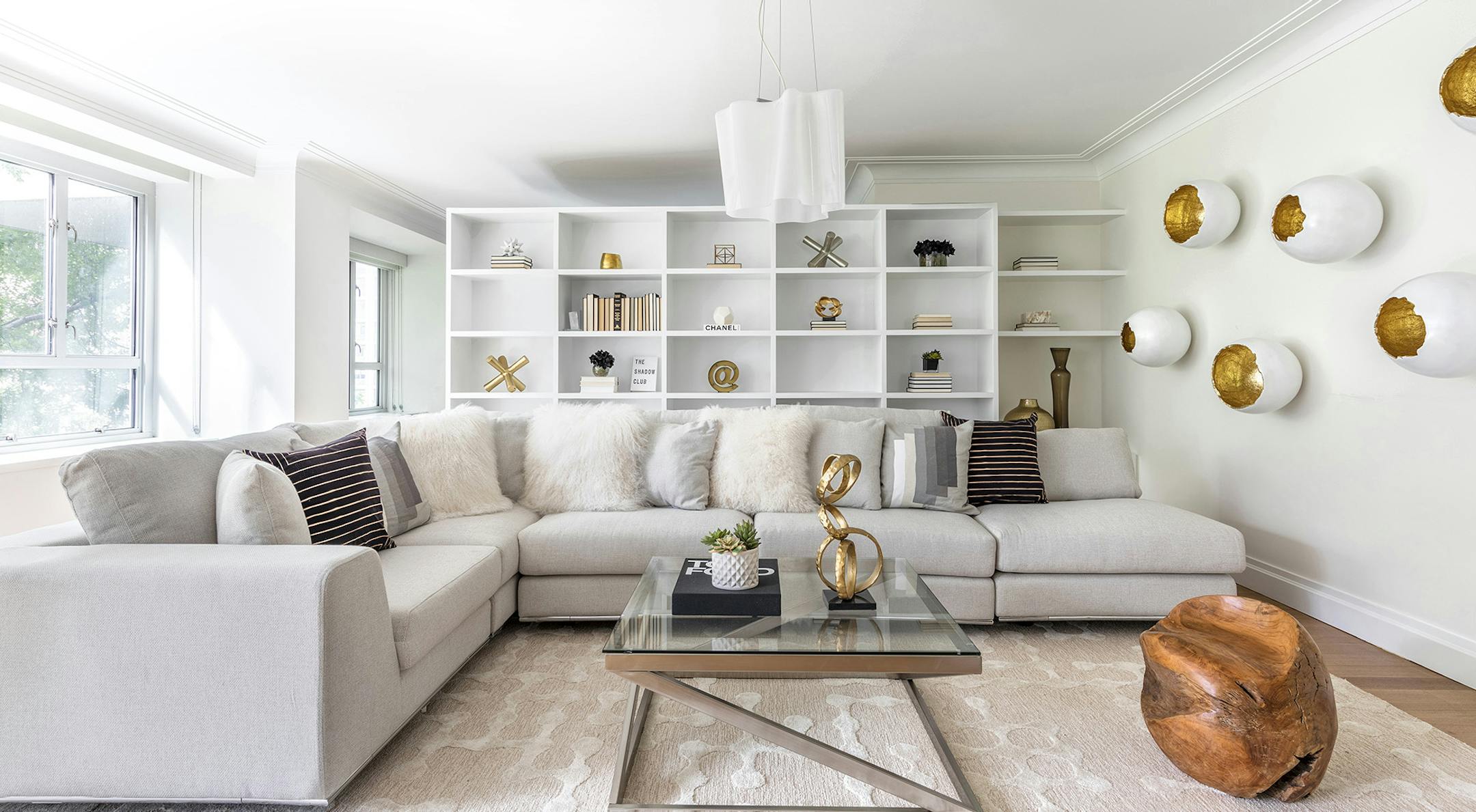 A mix of textures including faux fur pillows, a wood stump and an area rug with raised pile adds an element of comfort.